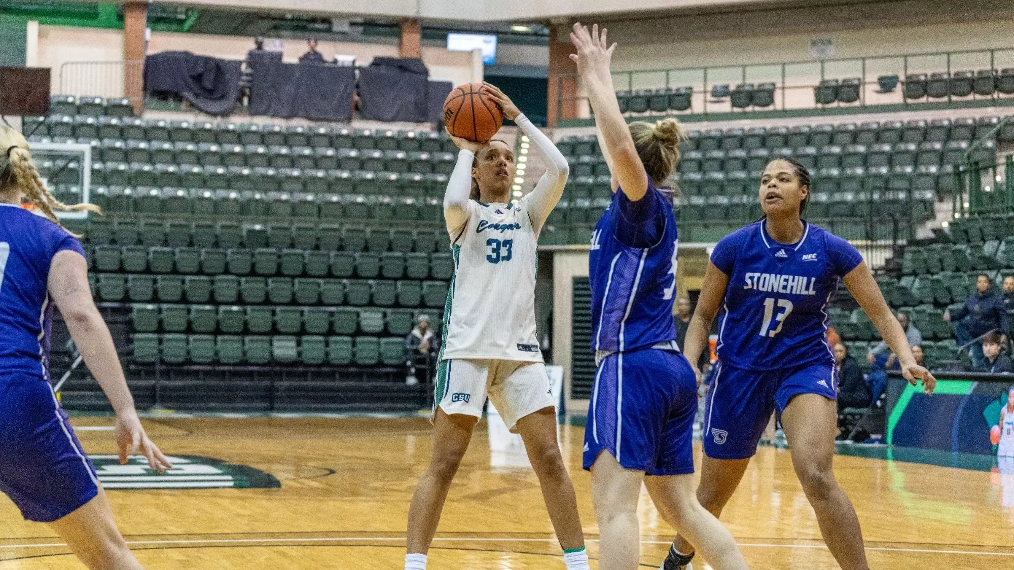 Women's Basketball student athlete Kace Urlacher shooting a basketball 