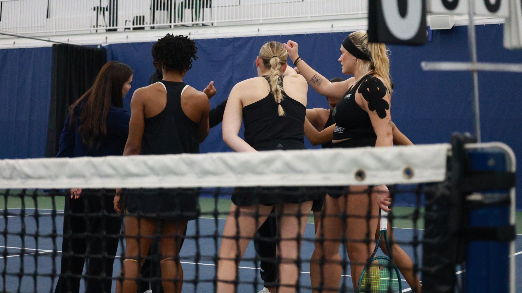 Women's Tennis team in their team a team huddle before their match against the Indiana Hooisers
