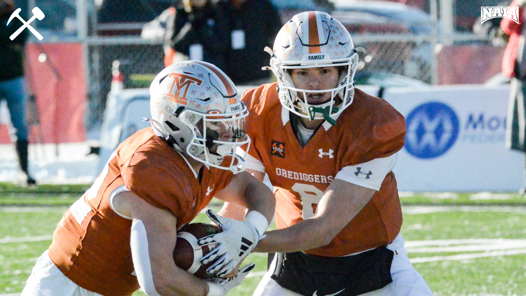 Jarrett Wilson hands the ball off to Nate Milanowski during a Montana Tech football home game.