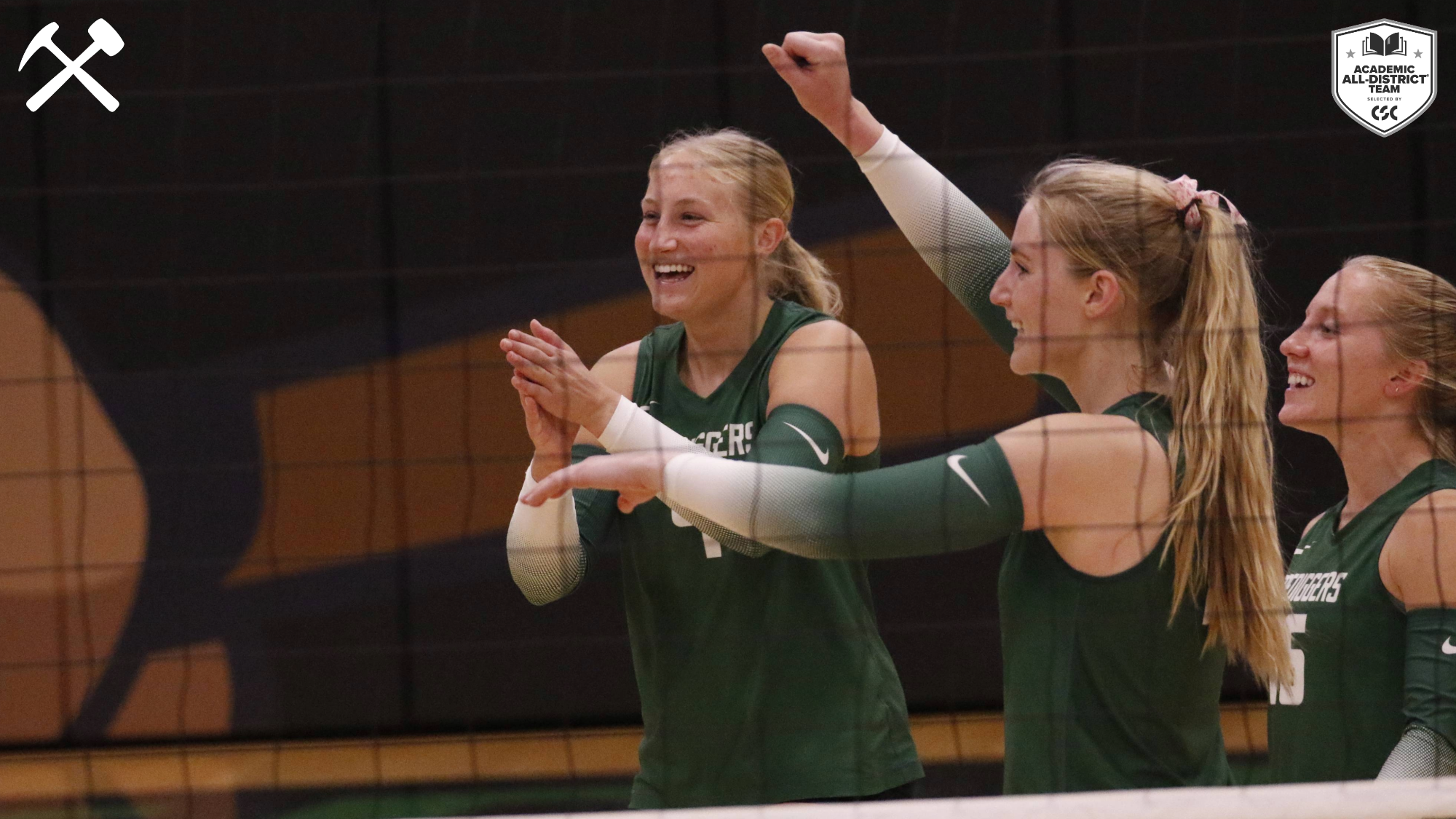 Montana Tech volleyball players celebrate a point during a home match