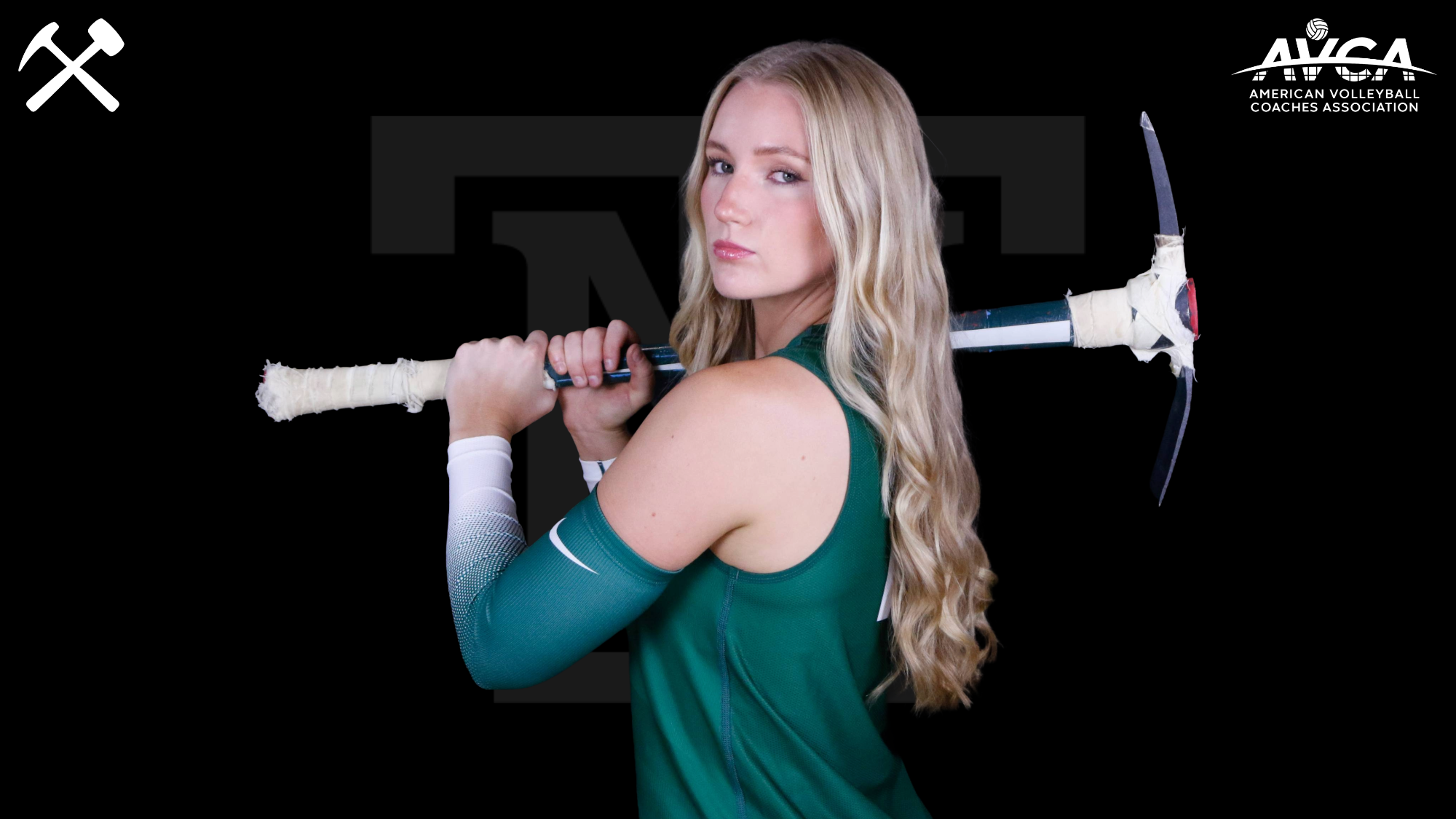 Kinnidi Willmore poses in a Montana Tech volleyball uniform with a pickaxe over her shoulder on a black background with Montana Tech and AVCA logos in the upper corners