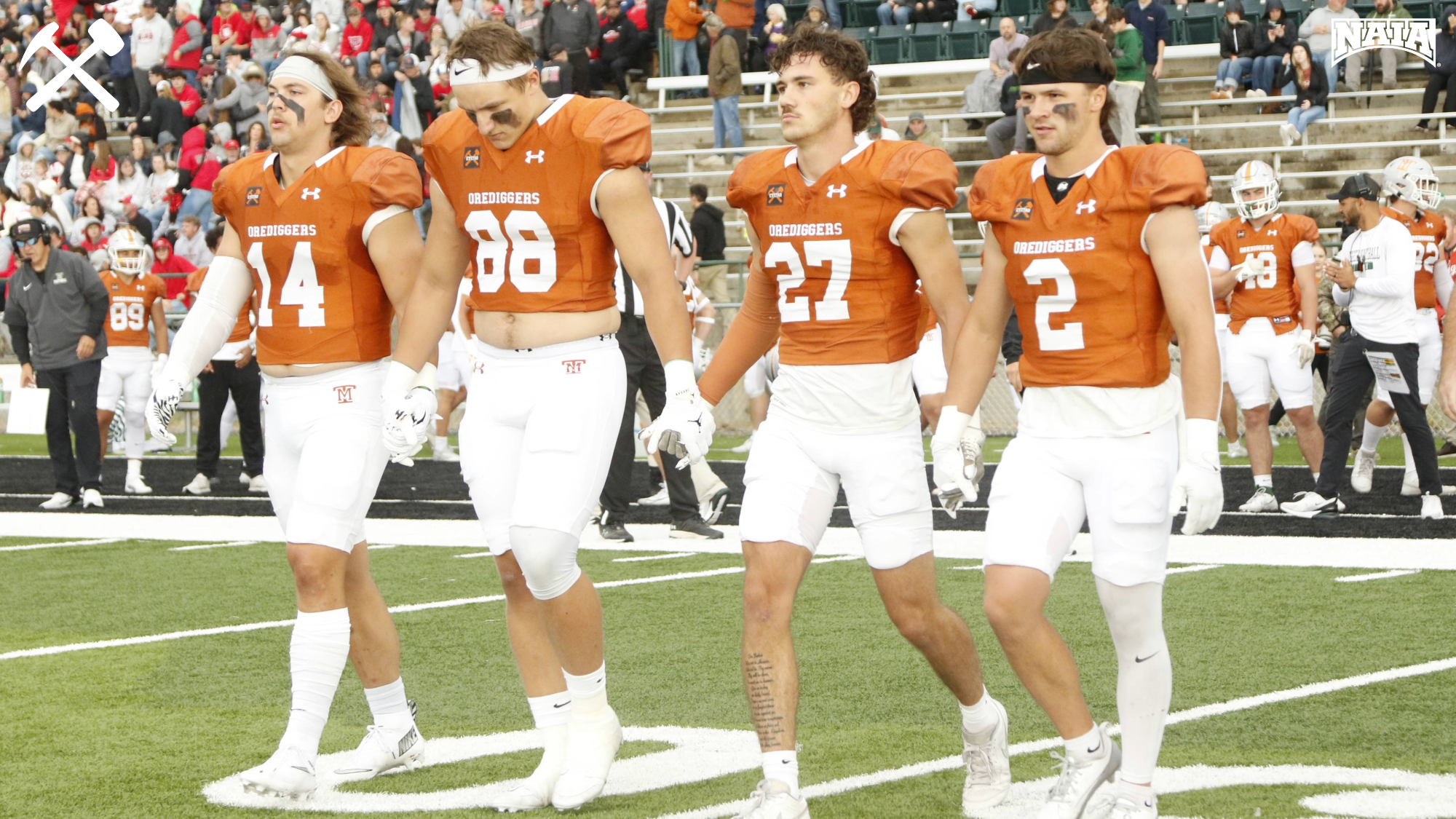 Montana Tech's football captains walk to midfield for the coin toss before a home game.