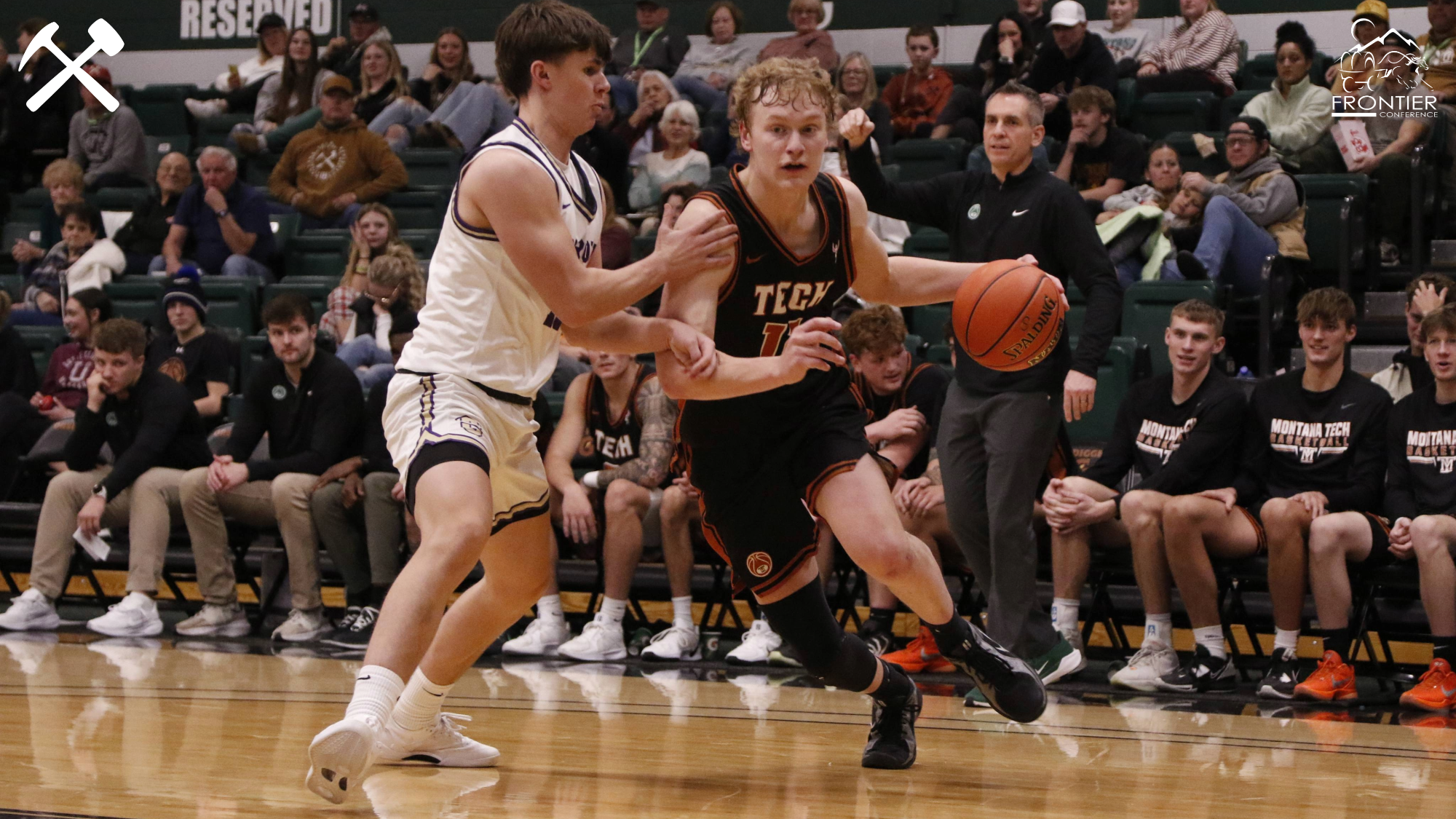 Hayden Diekhans drives against a defender during a Montana Tech men's basketball game