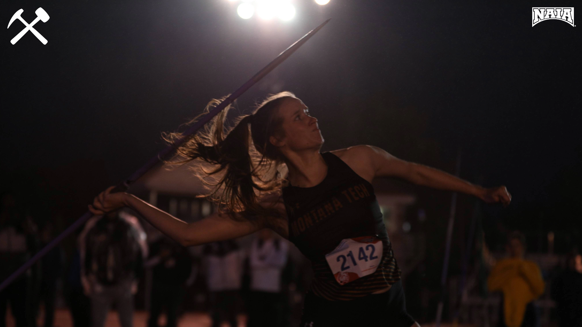 Jenna Jordan throwing the javelin in the dark at the NAIA outdoor national track & field meet