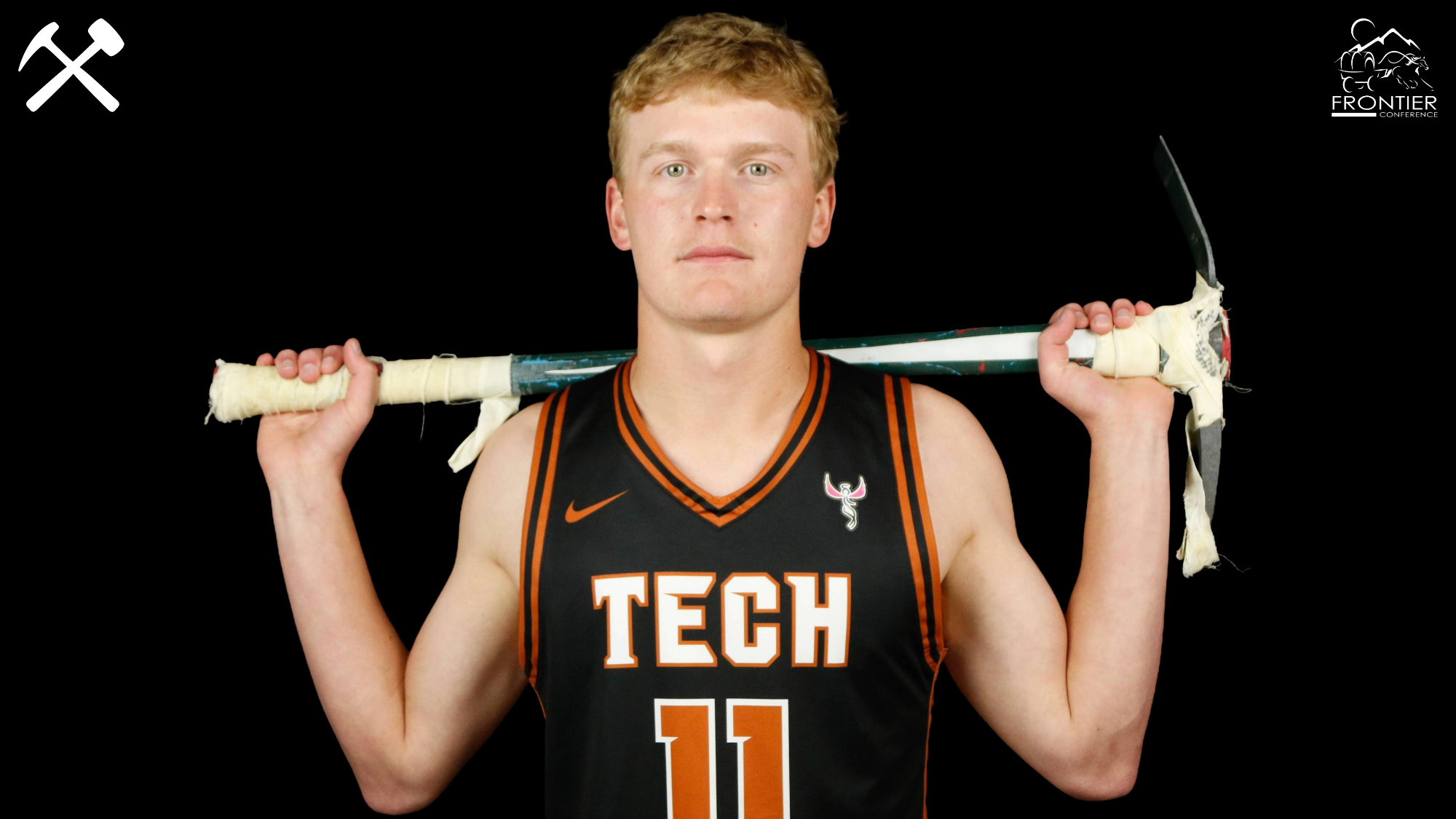 Hayden Diekhans in a Tech men's basketball uniform posing with a pickaxe over his shoulders