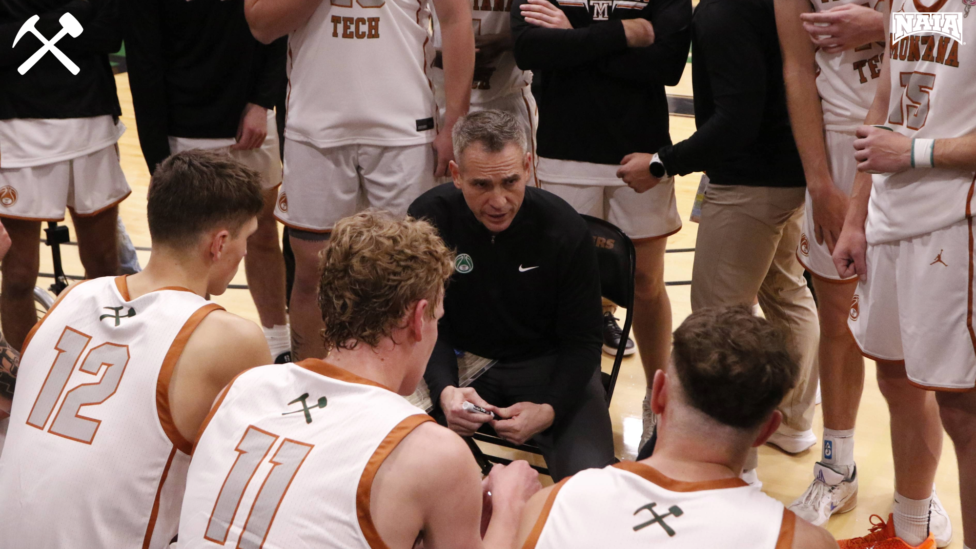 Montana Tech's men's basketball team huddles during a timeout