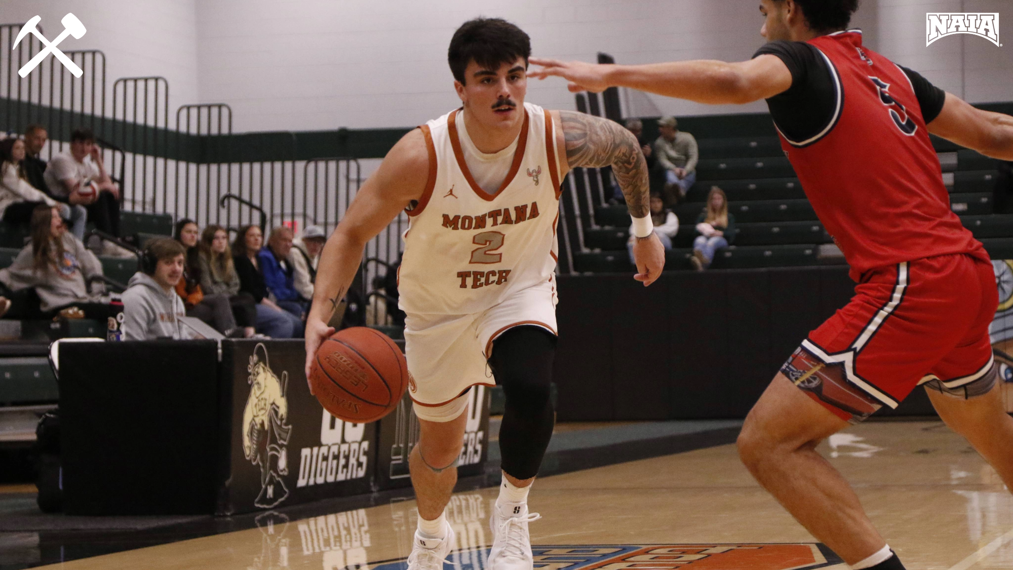 Cam LaRance drives against a defender during a Montana Tech men's basketball game