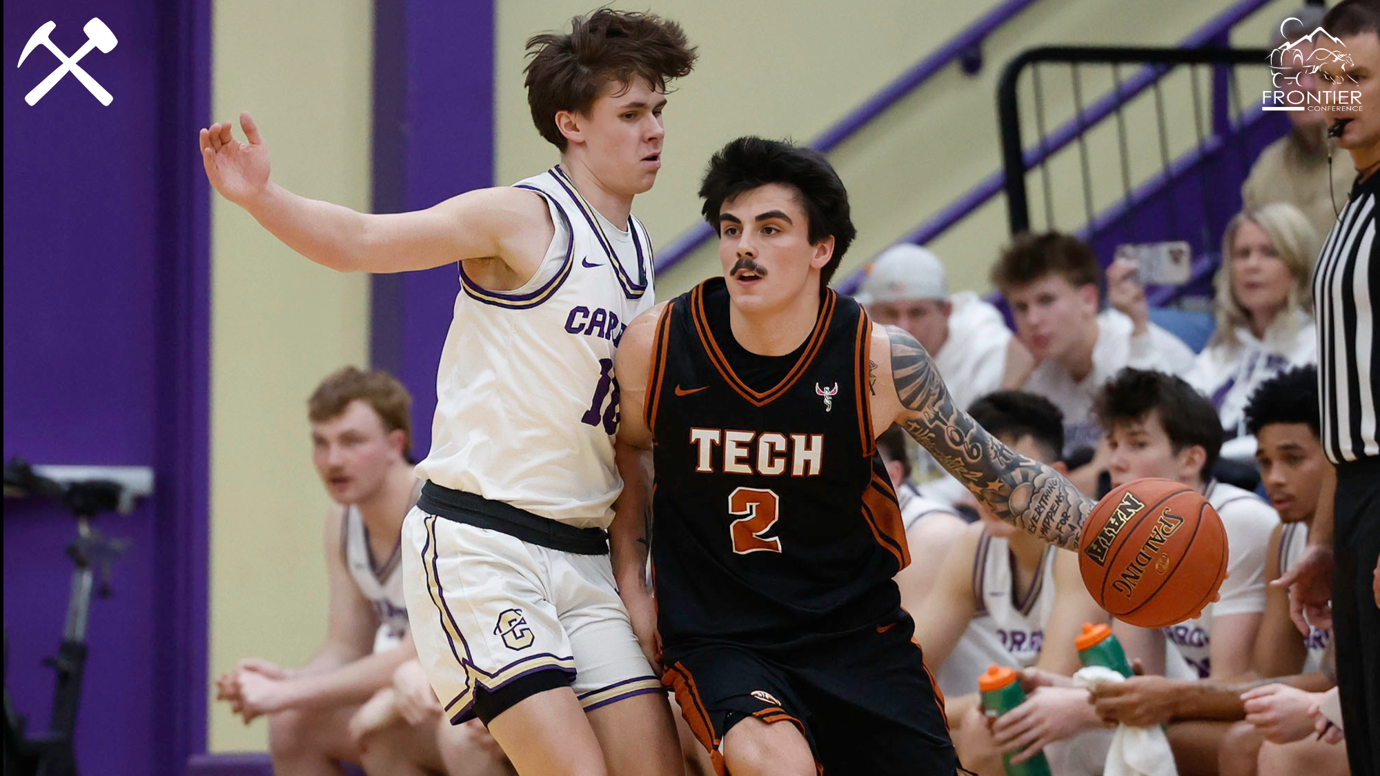Cam LaRance plays basketball against a Carroll defender