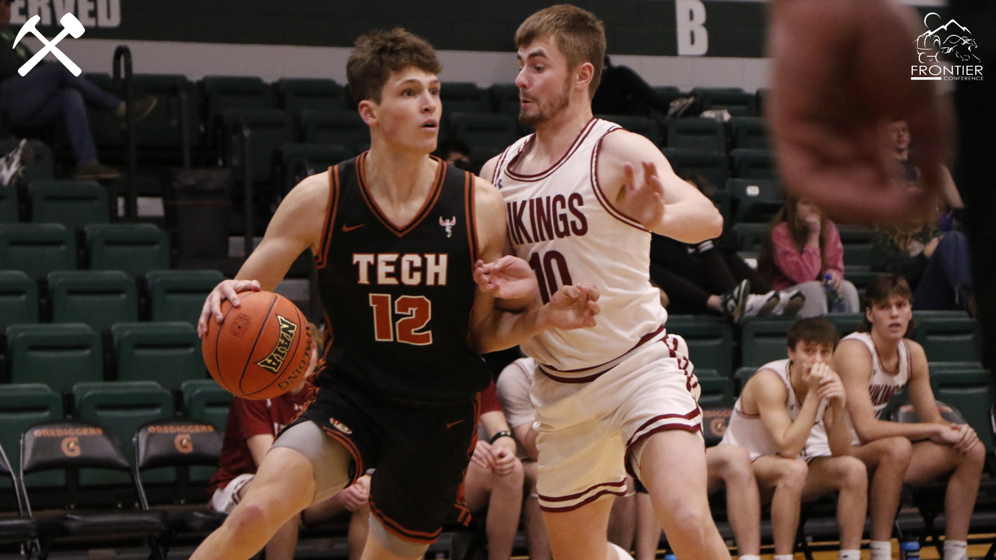 Asher Williams drives in a Montana Tech men's basketball game