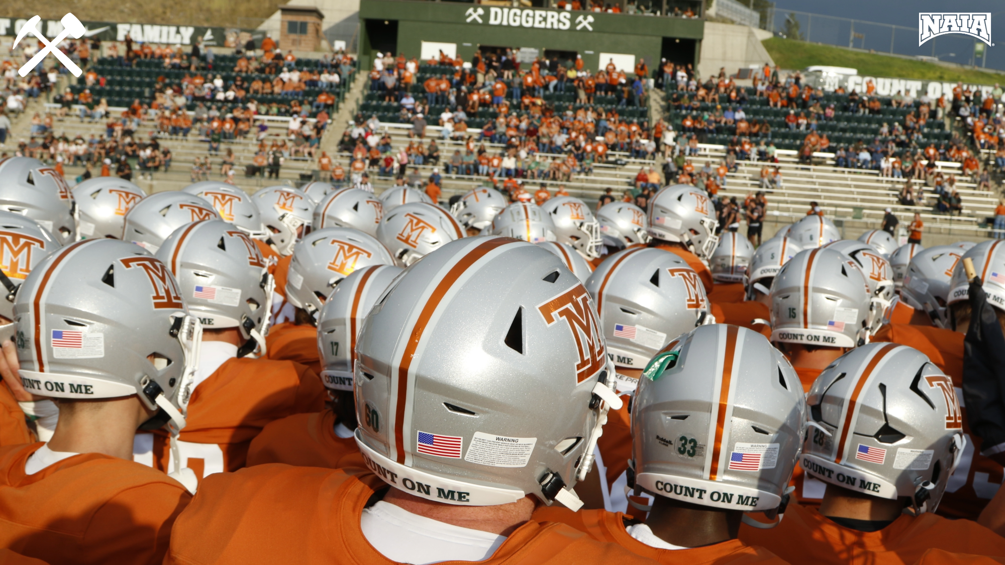 Montana Tech football team huddles before a home game