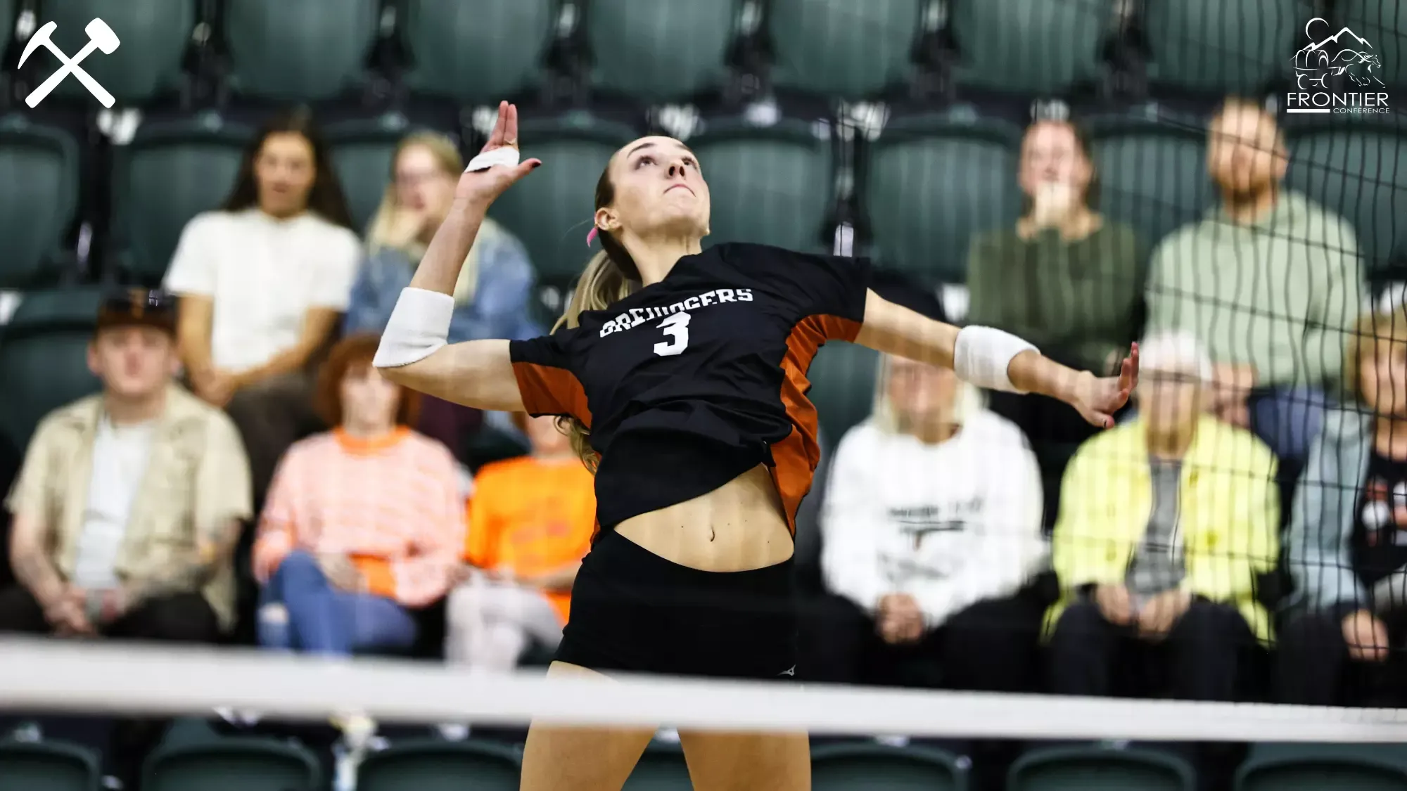 Talan Dodson jumps to spike a volleyball