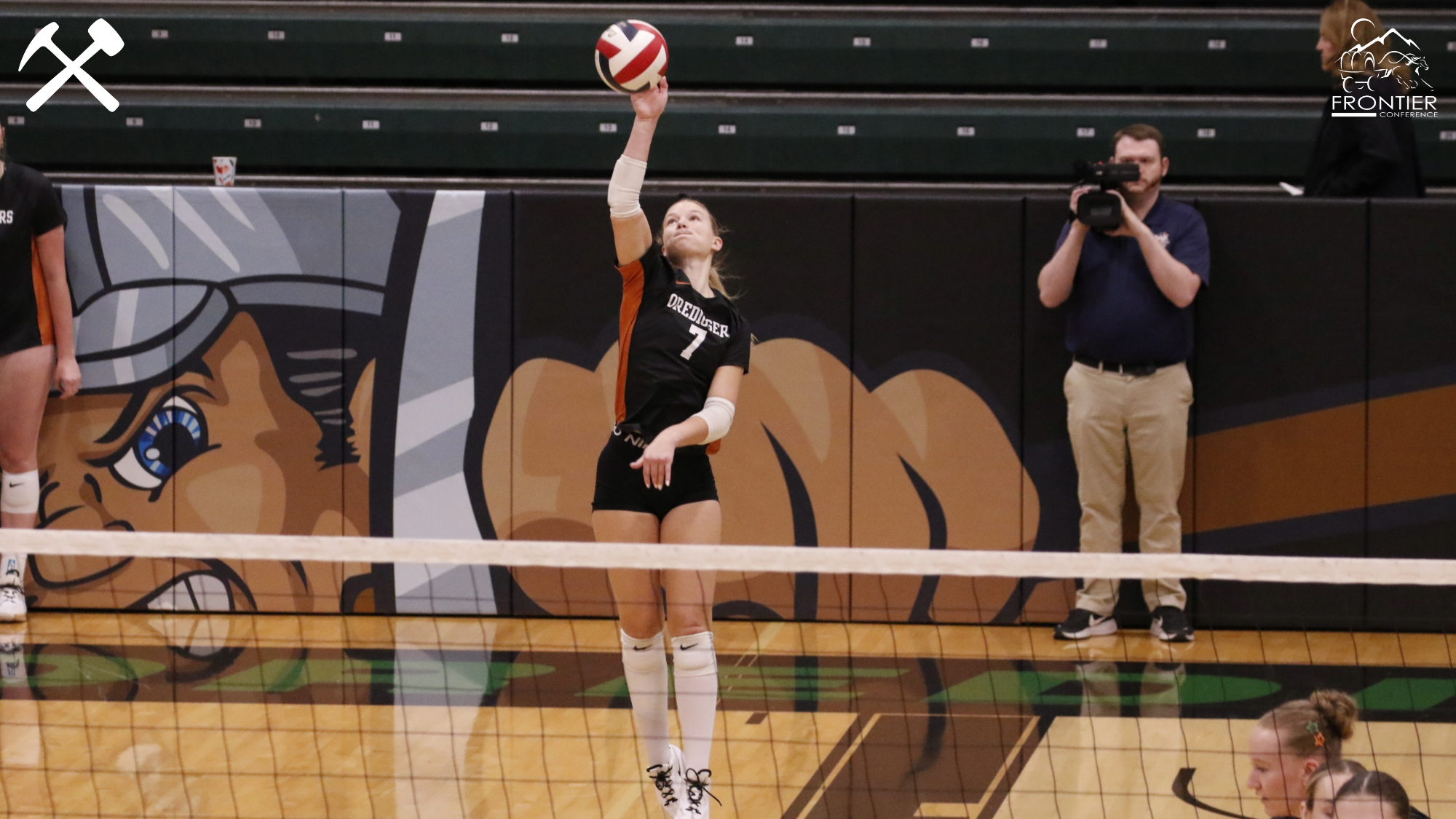 Morgan Jones serving in a Montana Tech volleyball match