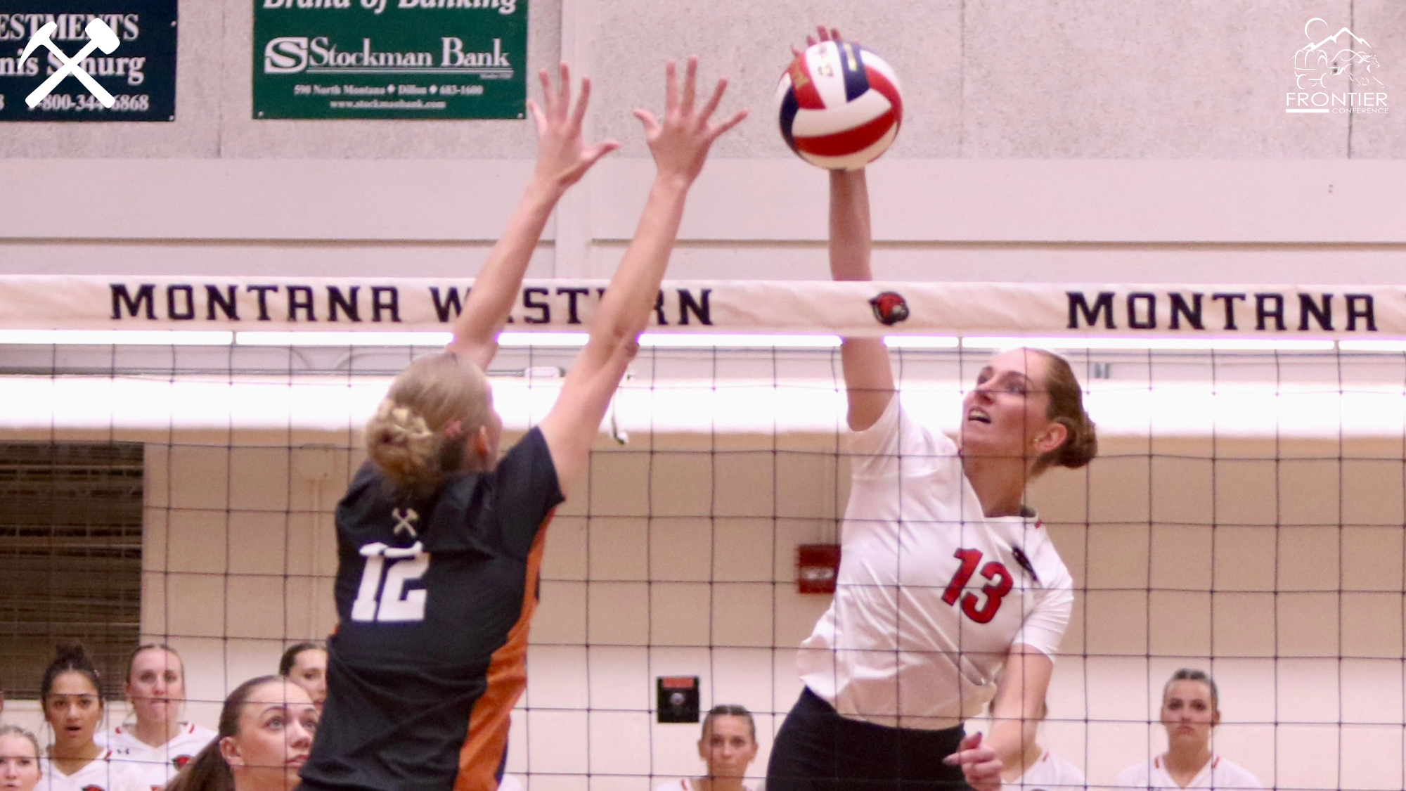 Kennedy Oman jumps to block a Western attacker in a volleyball match