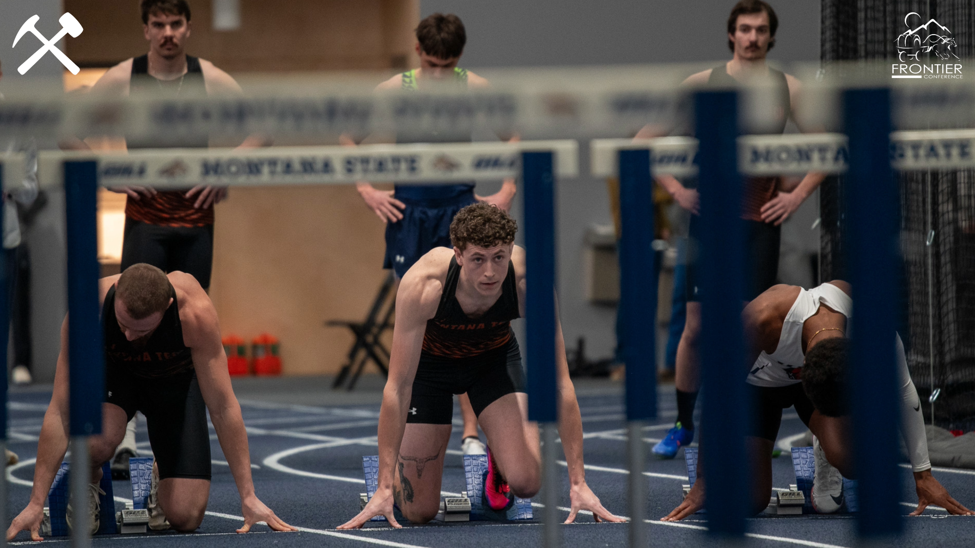 Montana Tech track & field athletes prepare to race the 60m hurdles at an indoor meet
