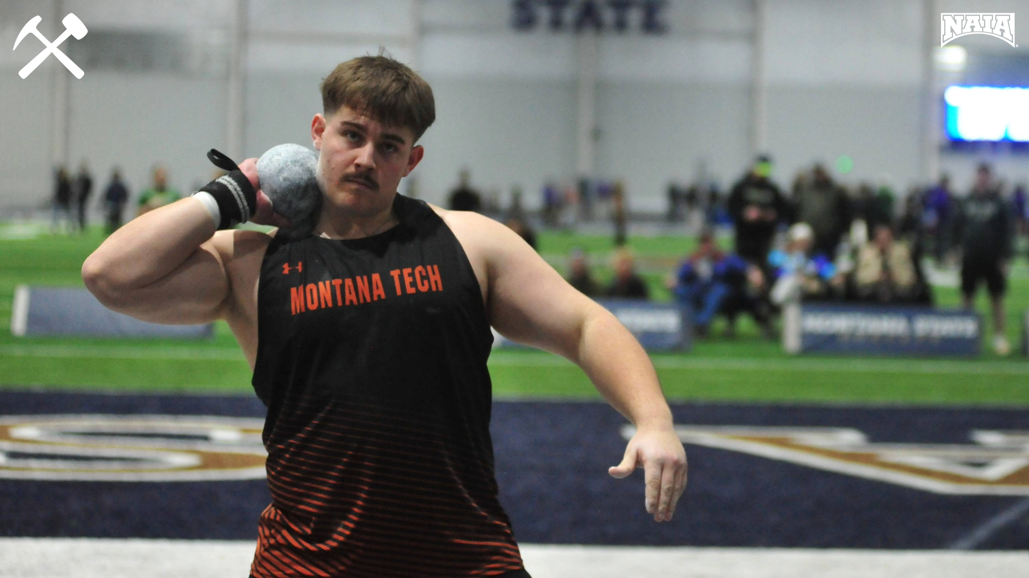 Cade VanVleet prepares to throw the shot put in an indoor track & field meet