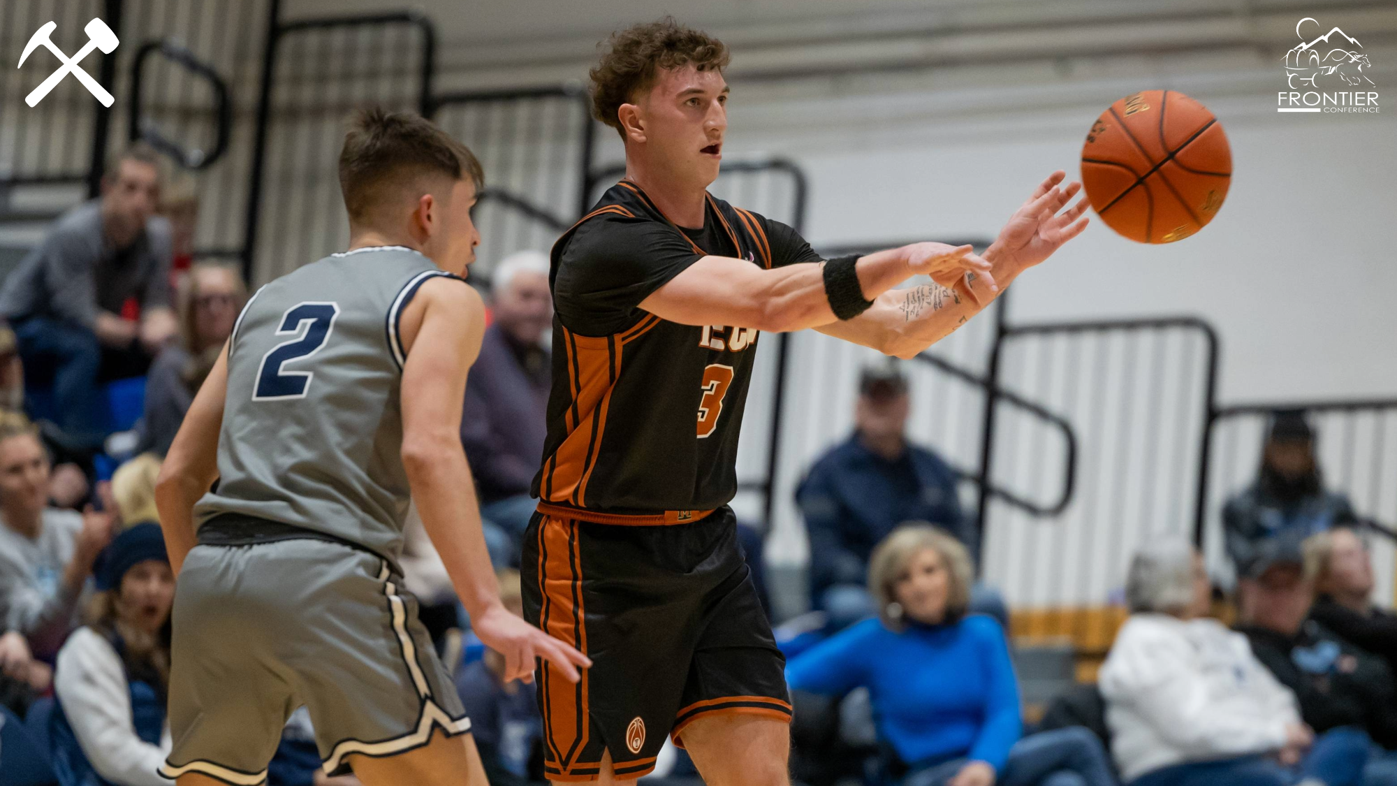Brayden Koch passes the basketball in a Montana Tech men's game