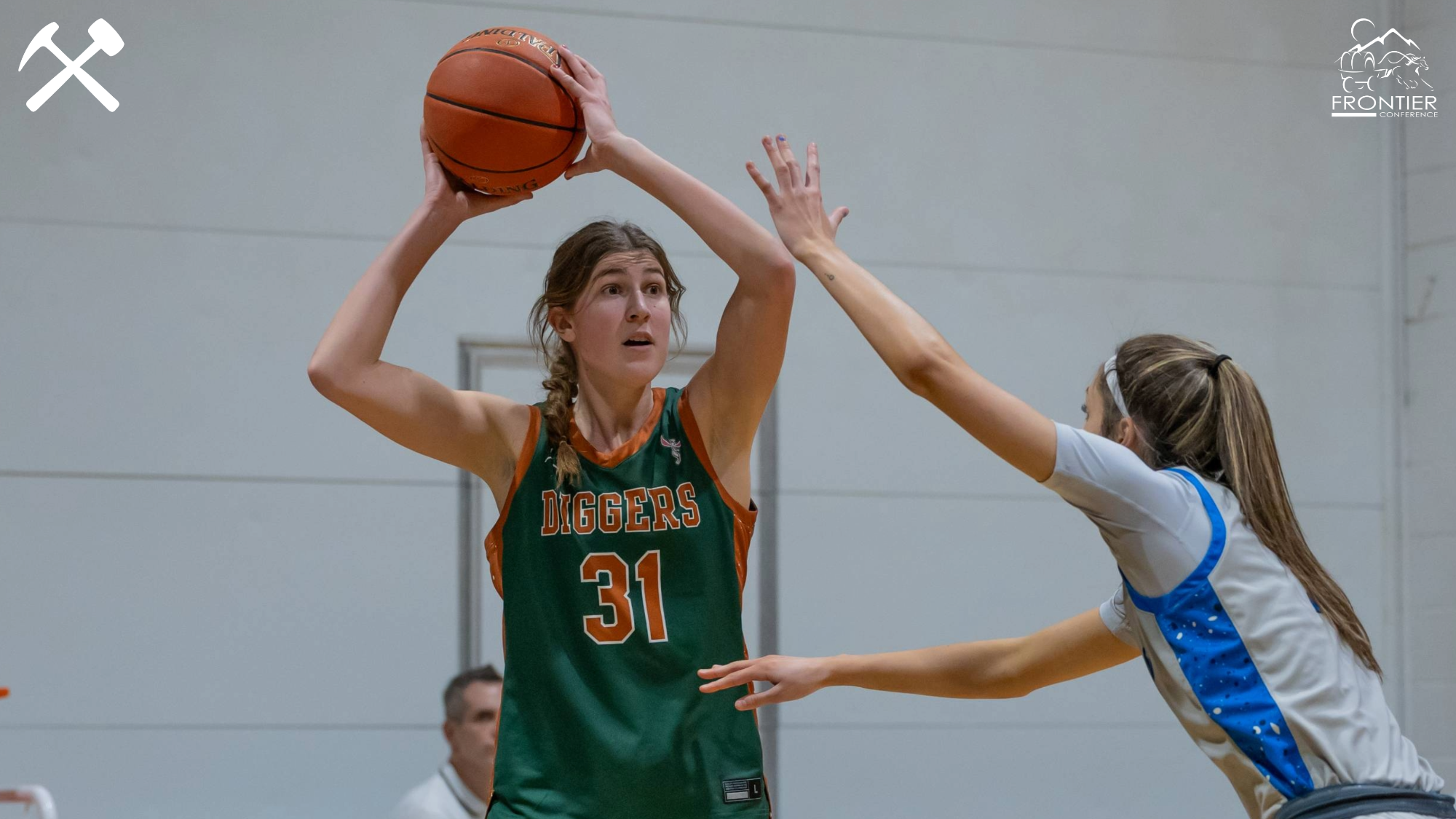 Halle Haber looks to pass the ball in a road women's basketball game