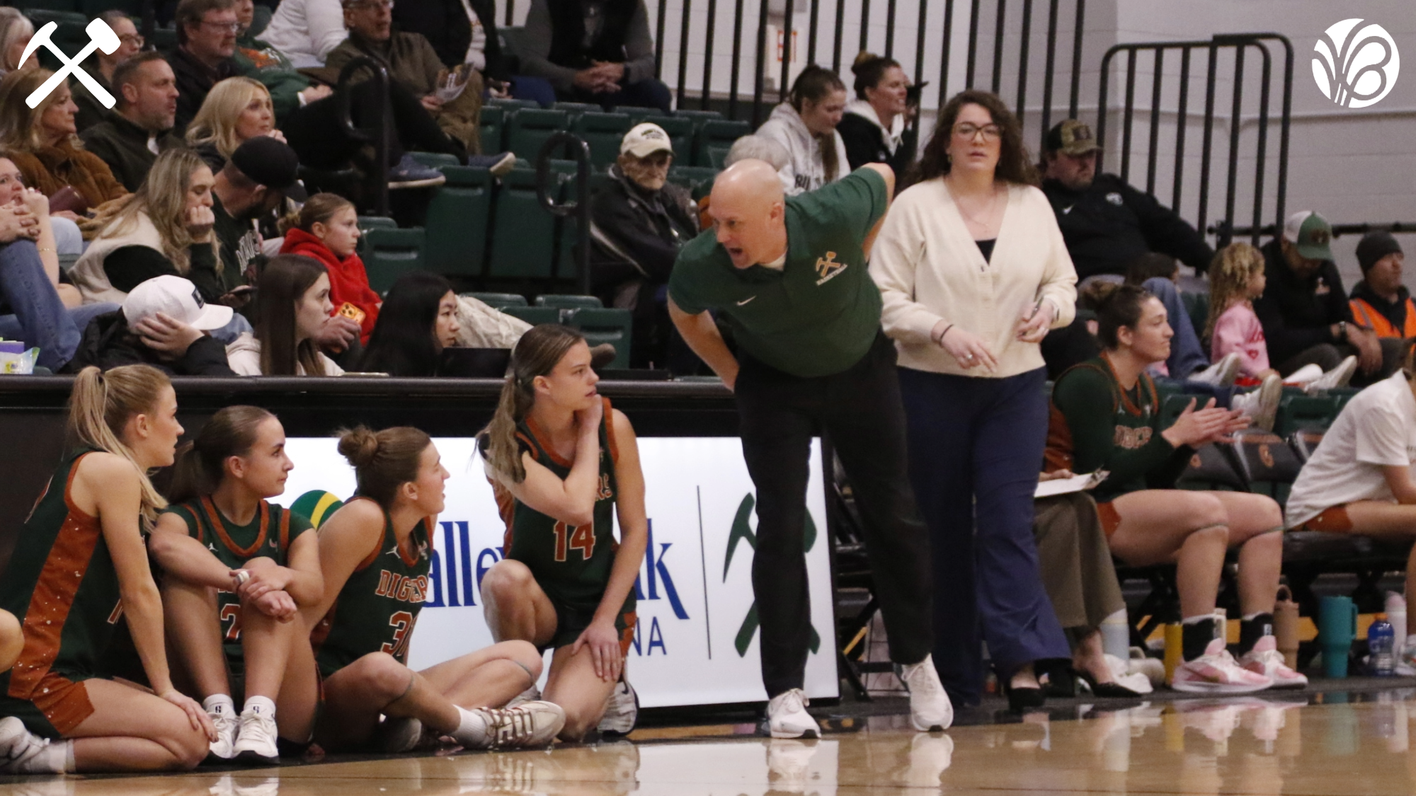 Montana Tech women's basketball players wait on the sideline to check into the game.
