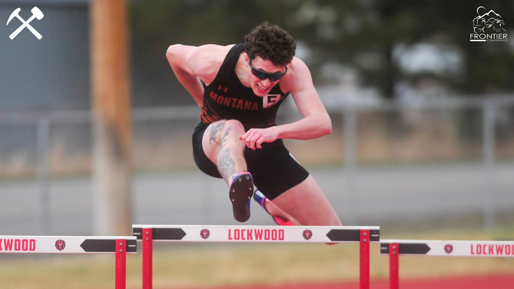 Morgan McClernan clears a hurdle in a track race