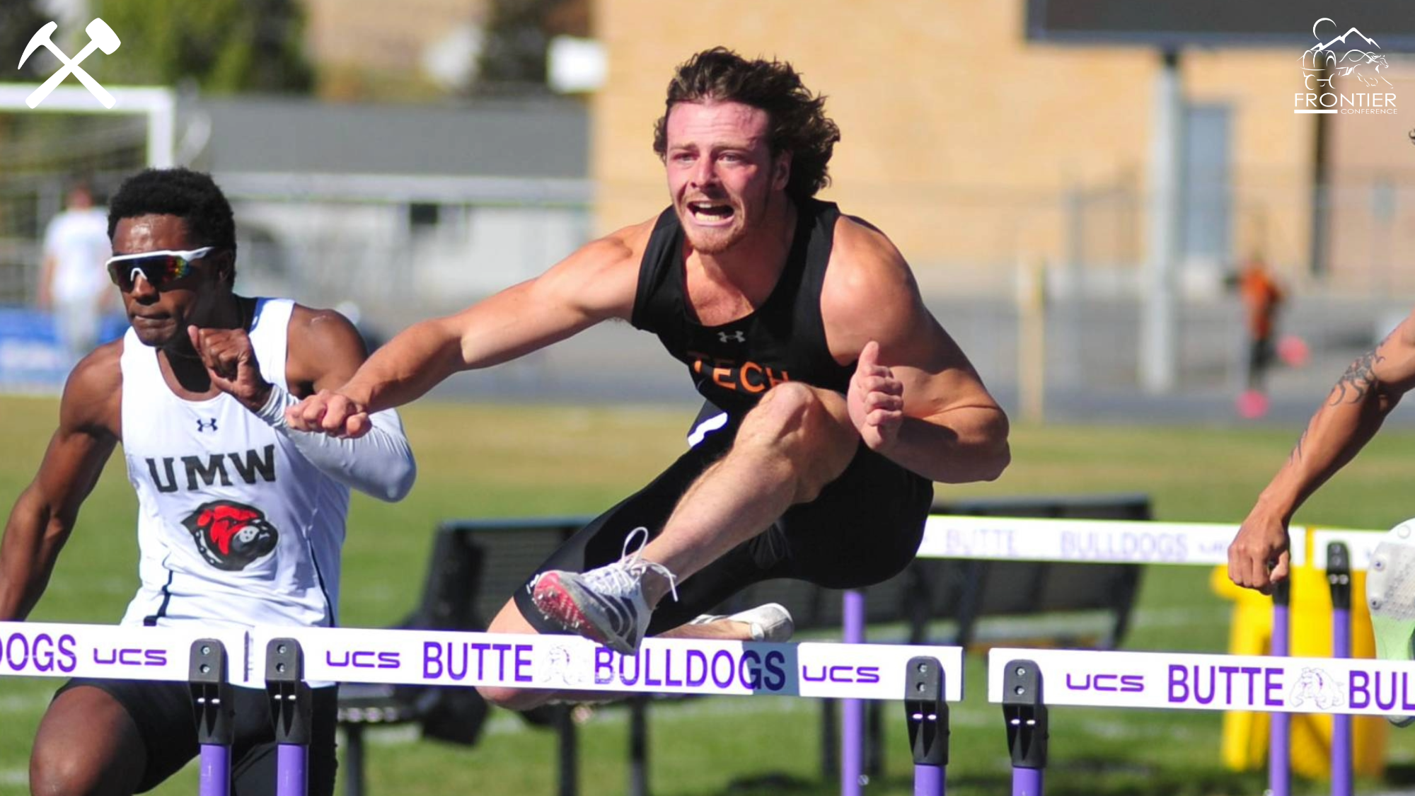 Adam Schrader running the hurdles on a track