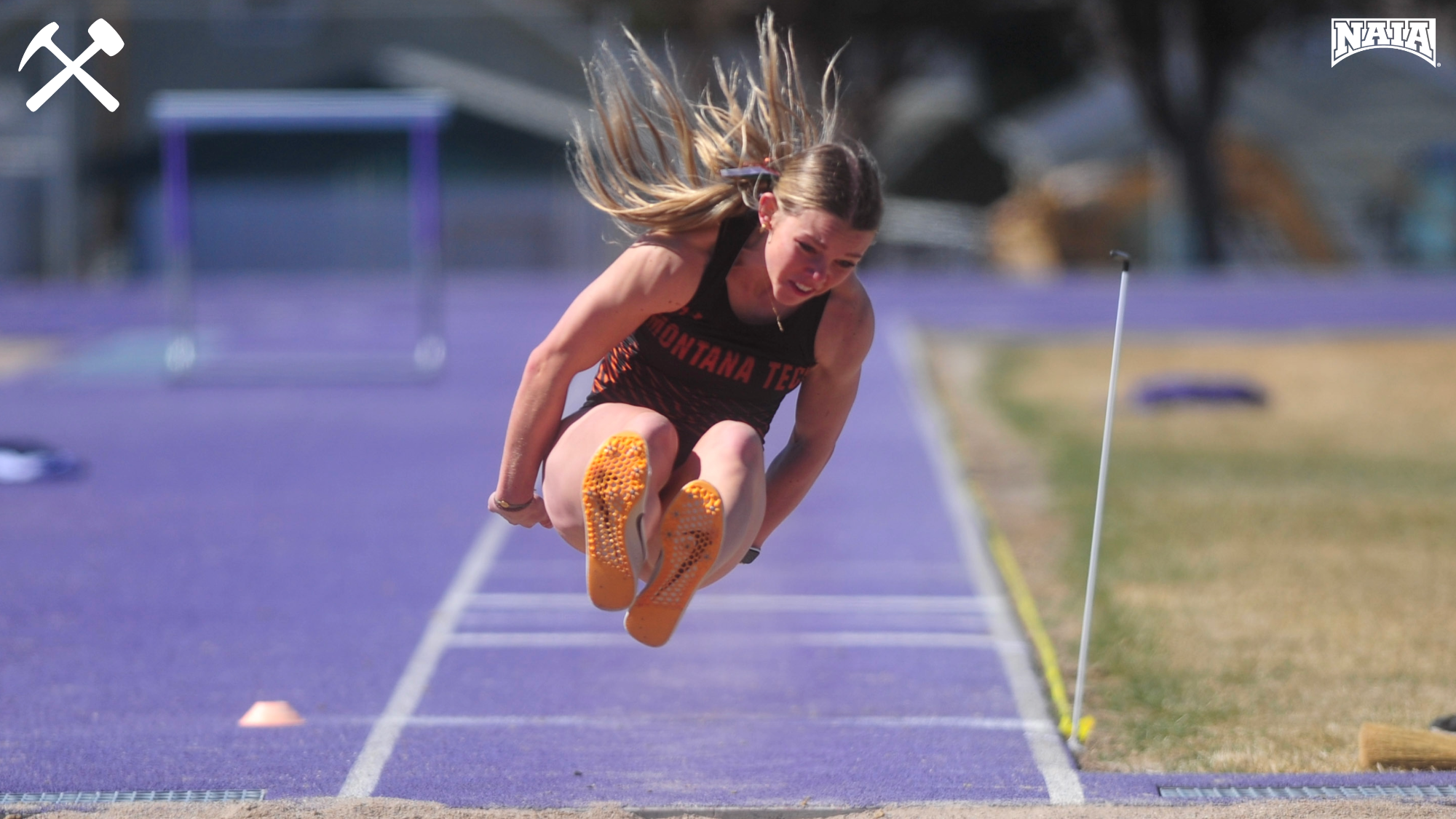 Ayla Janzen jumping in the long jump during a home meet