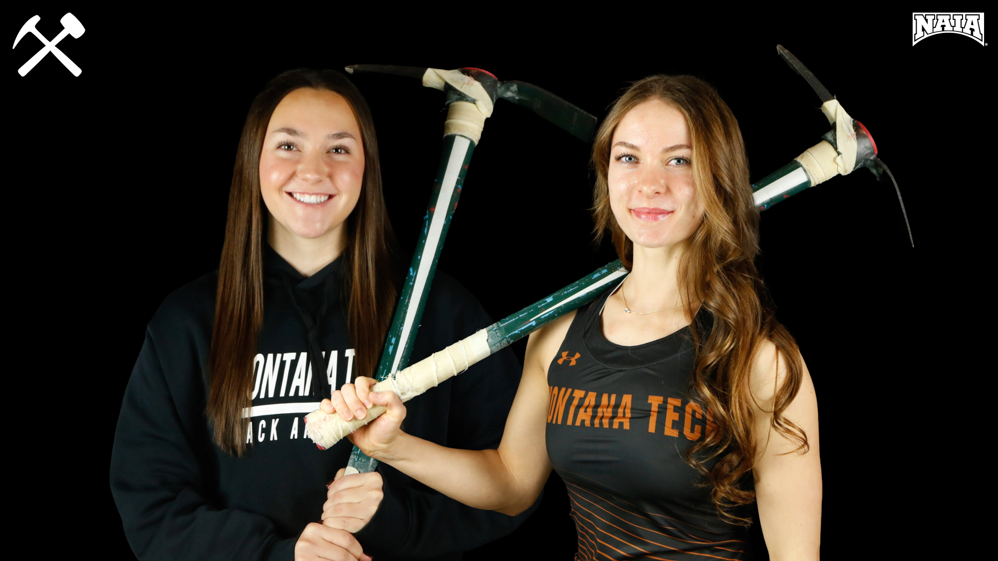 Brityn Stewart and Tyra Opperman pose with pickaxes wearing Montana Tech track & field apparel on a black background