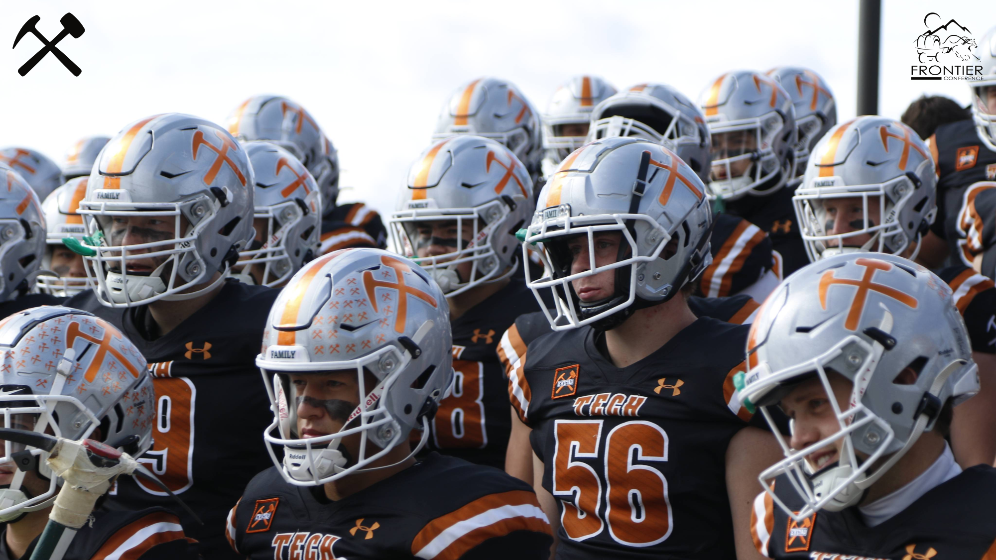Montana Tech Football players stand in uniform ready to take the field for a game
