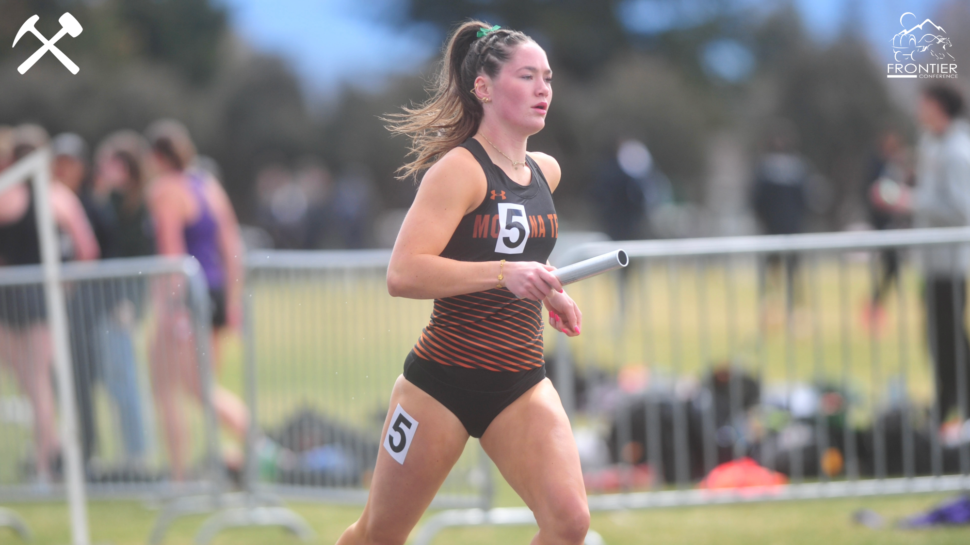 Peyton Walker runs with a relay baton
