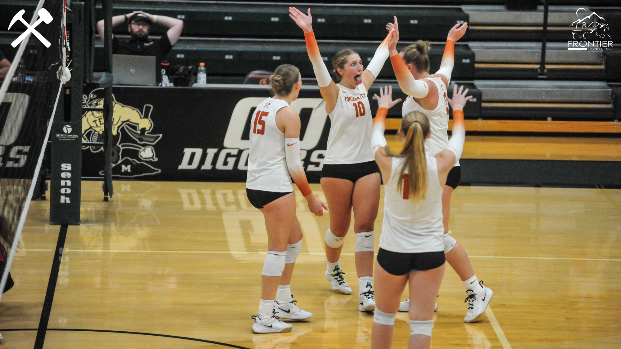 Montana Tech volleyball players celebrate a point during a match