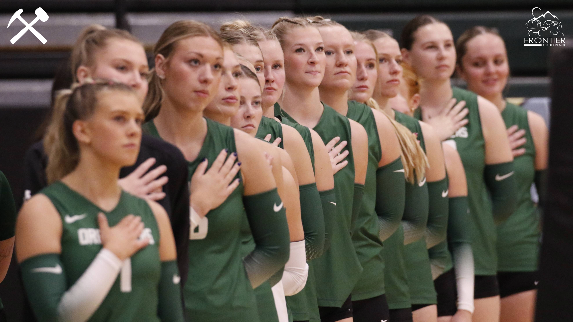 Montana Tech's volleyball team stands with hands over hearts for the anthem