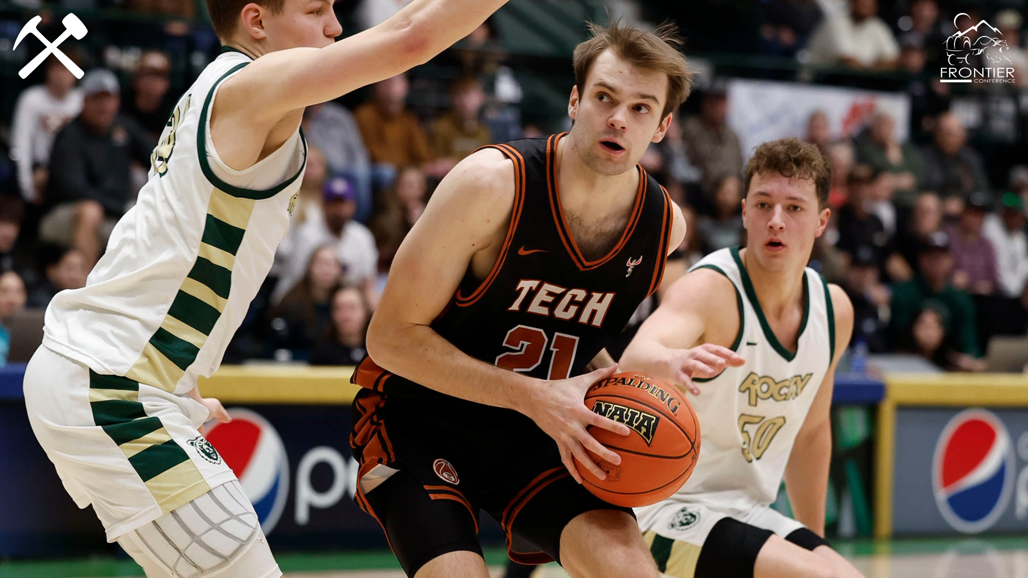 Rhett Reynolds prepares to shoot the ball over a defender during a Montana Tech men's basketball game