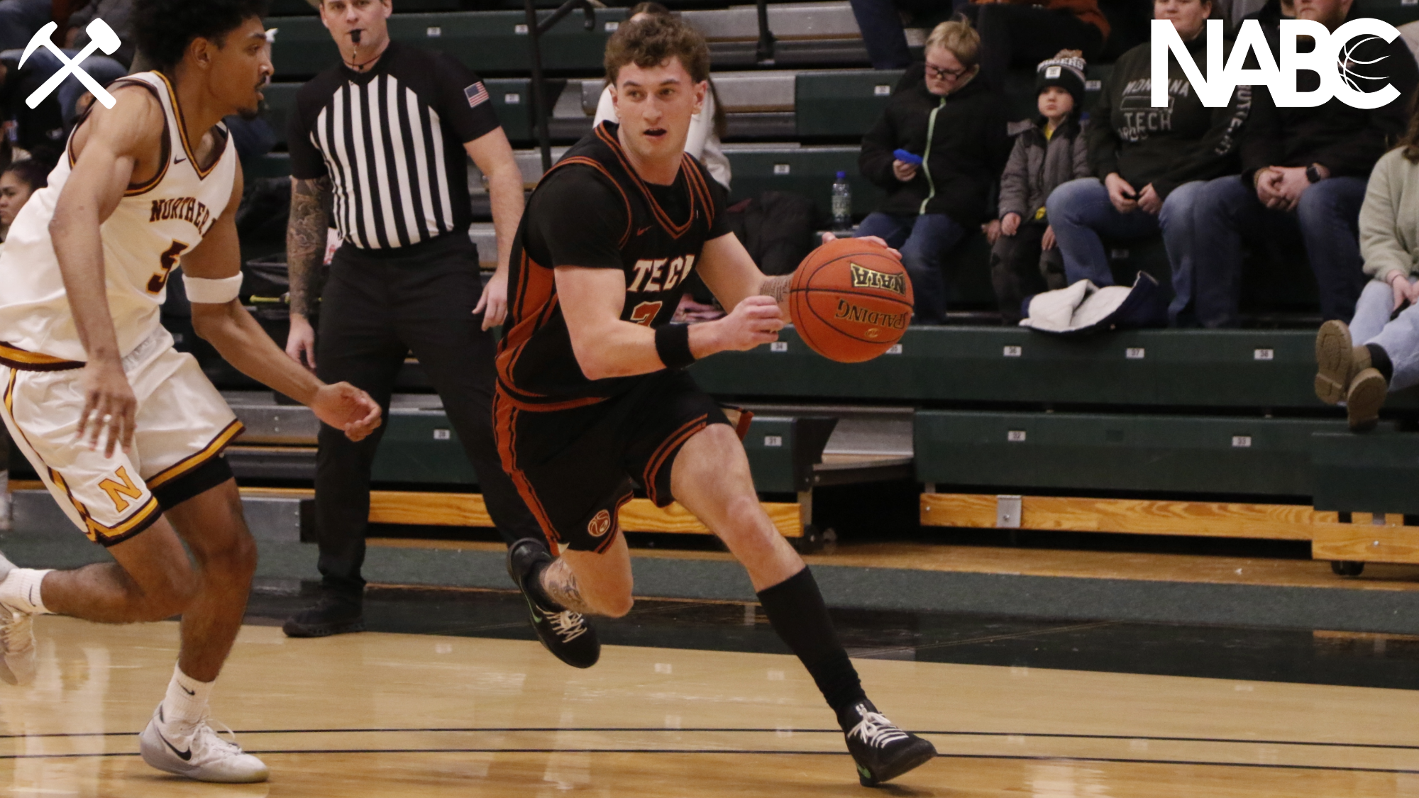 Brayden Koch drives with the basketball during a Montana Tech home game