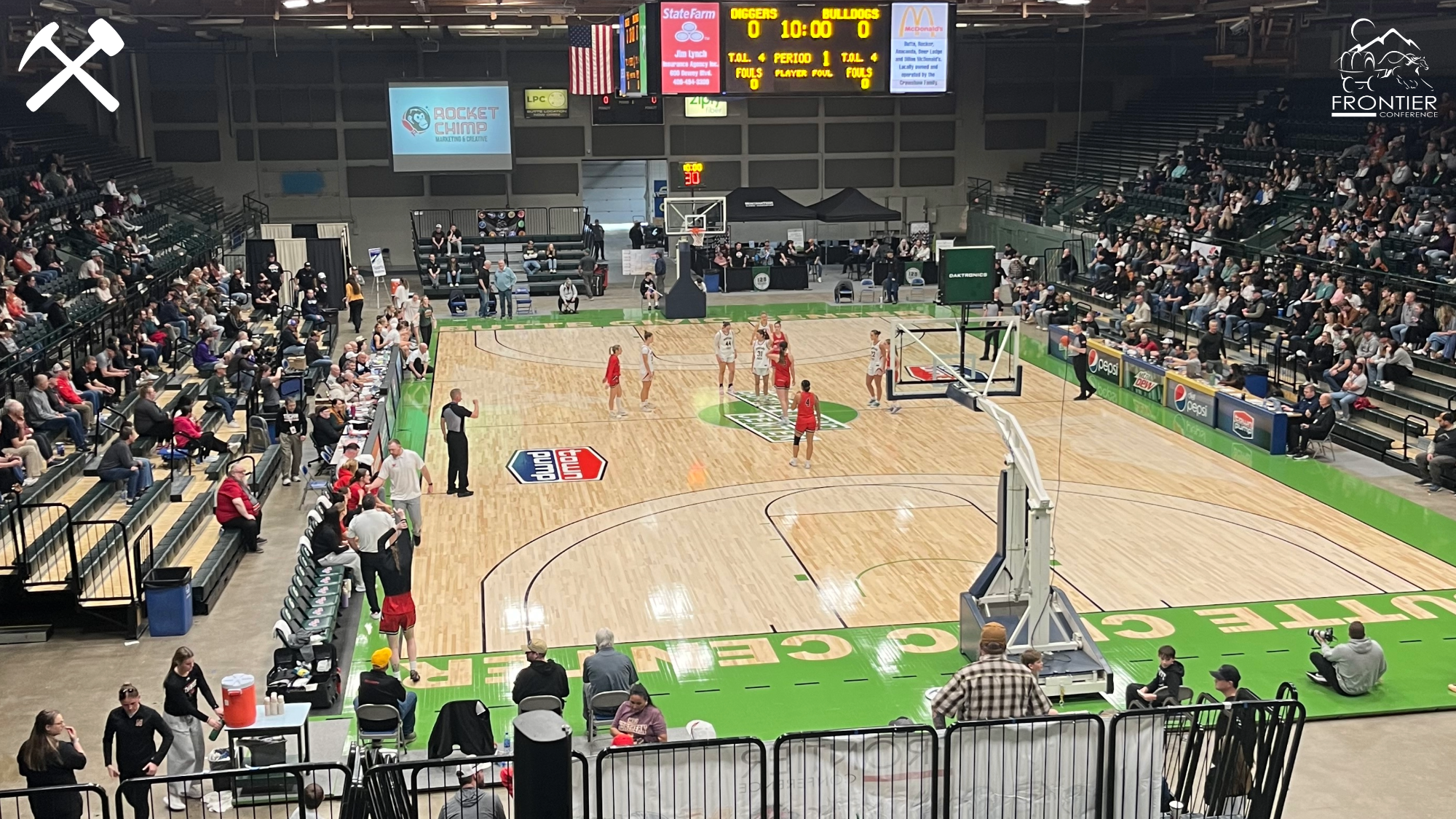 Wide angle photo of action on the court at the Butte Civic Center during the 2026 Frontier Conference basketball tournament