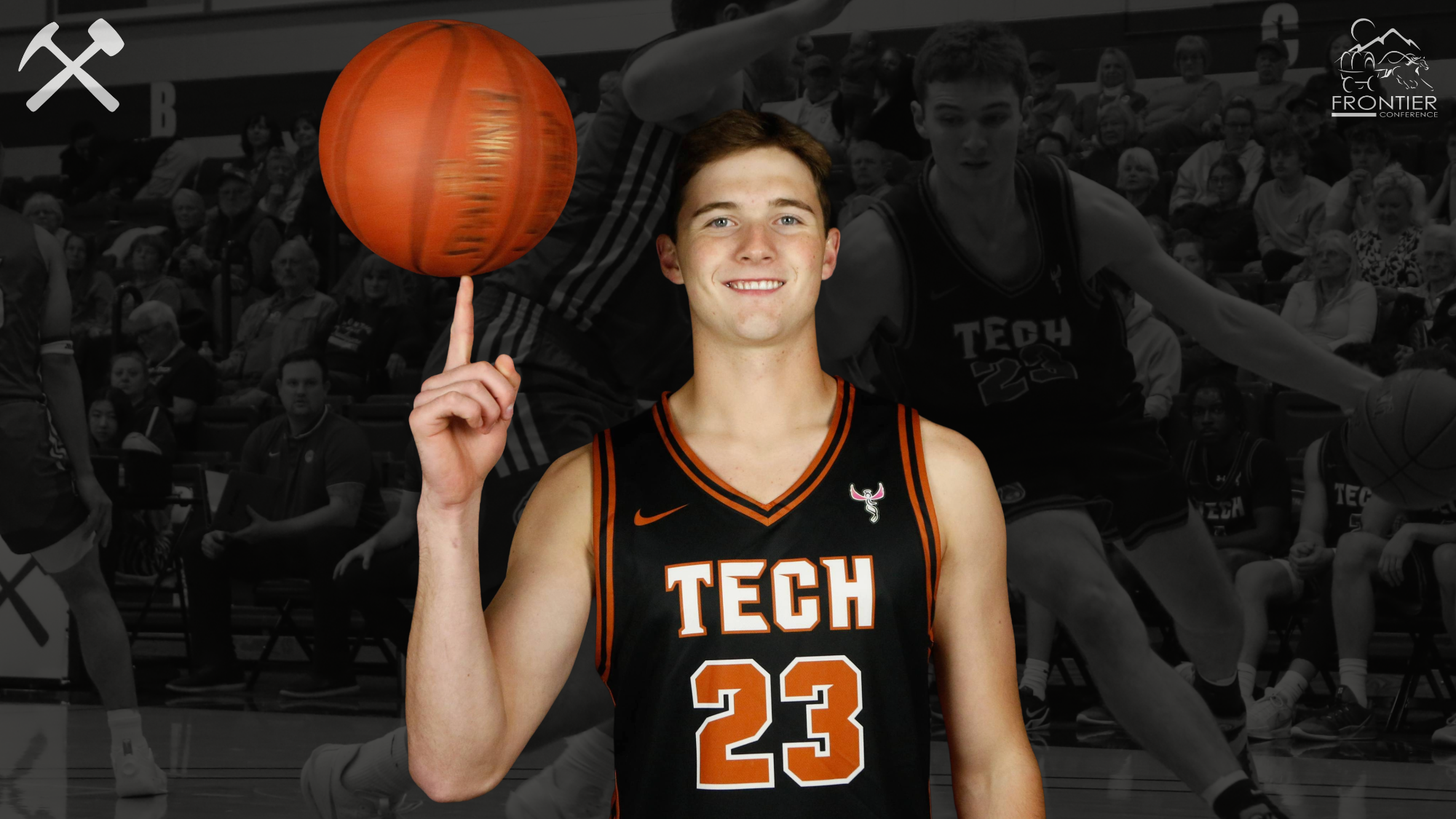 Connor Michaud standing in a black Montana Tech basketball uniform spinning a basketball on his right hand