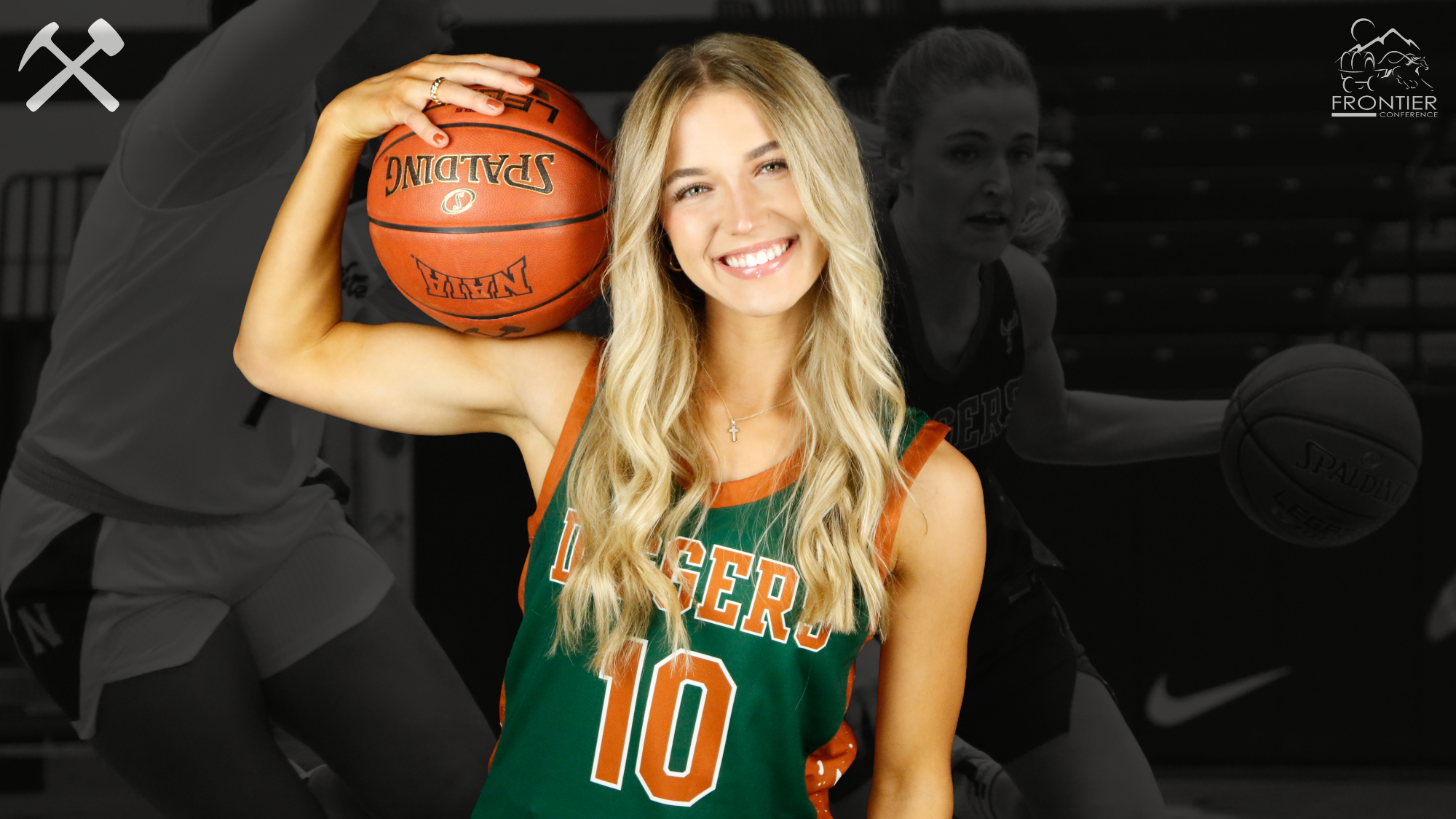 Avery Carlson in a green Montana Tech uniform holding a basketball on her biceps