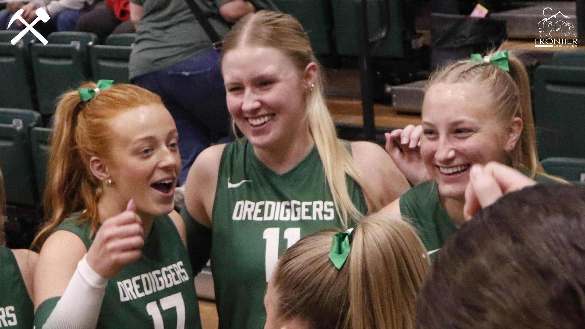Montana Tech volleyball players laugh in the huddle during a match.