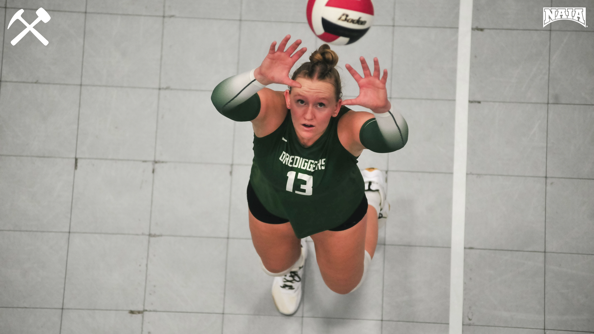 Rhys Layton sets the volleyball during a Montana Tech match
