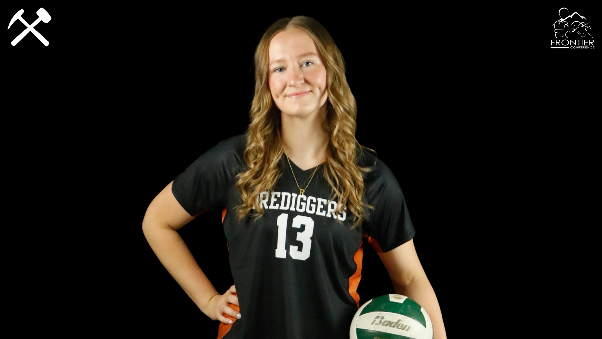 Rhys Layton standing in a Montana Tech volleyball uniform holding a volleyball.