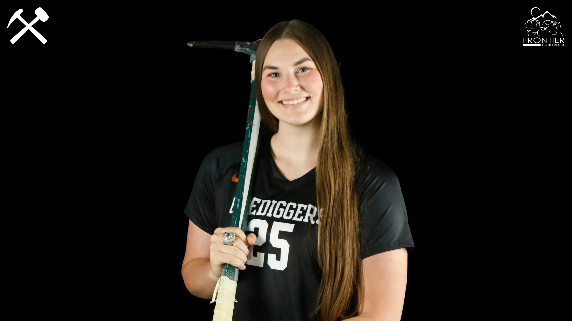 Halle Moomaw stands with a picaxe in a Montana Tech volleyball uniform
