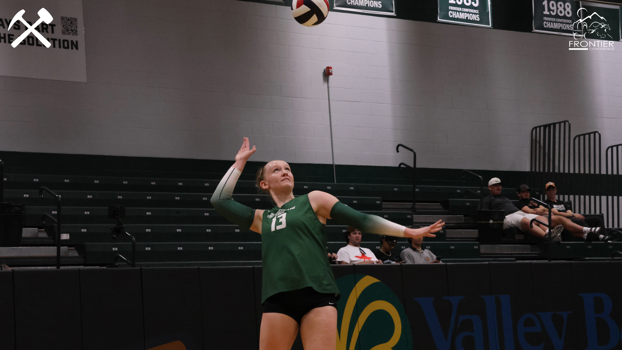 Rhys Layton serves in a Montana Tech volleyball match