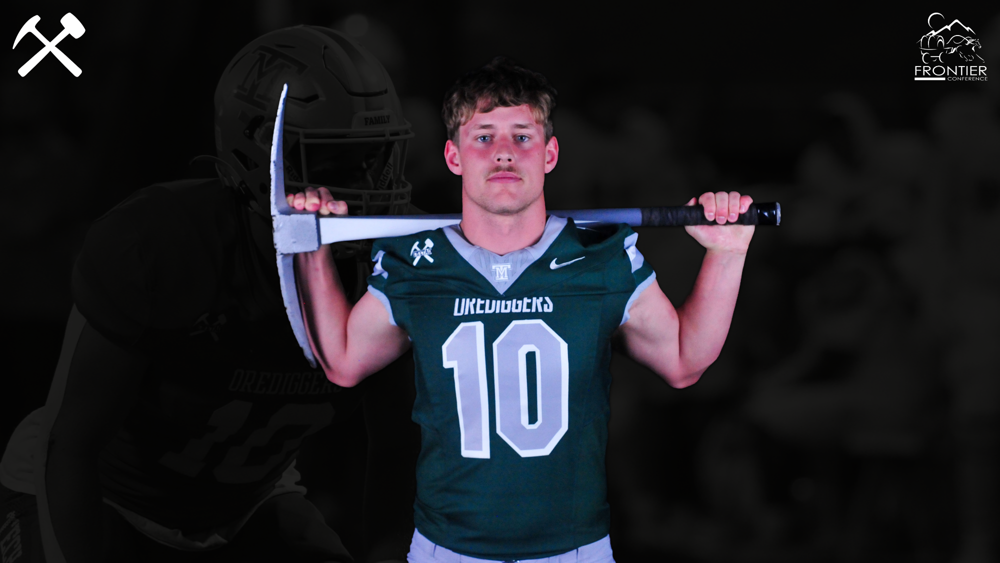 Kellan Beller standing in a Montana Tech uniform with a pickaxe over his shoulders