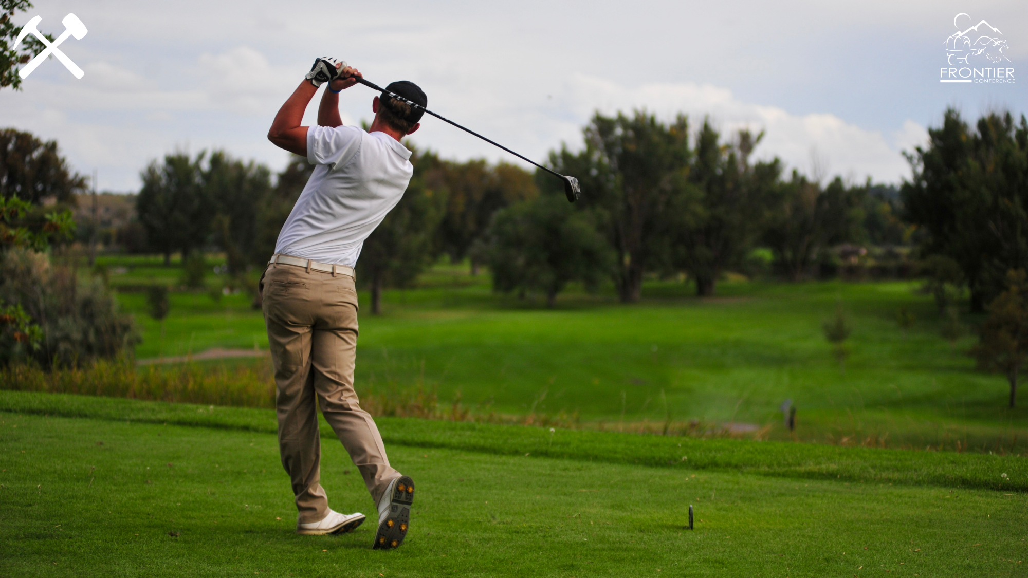 rear view of a golfer teeing off on a hole