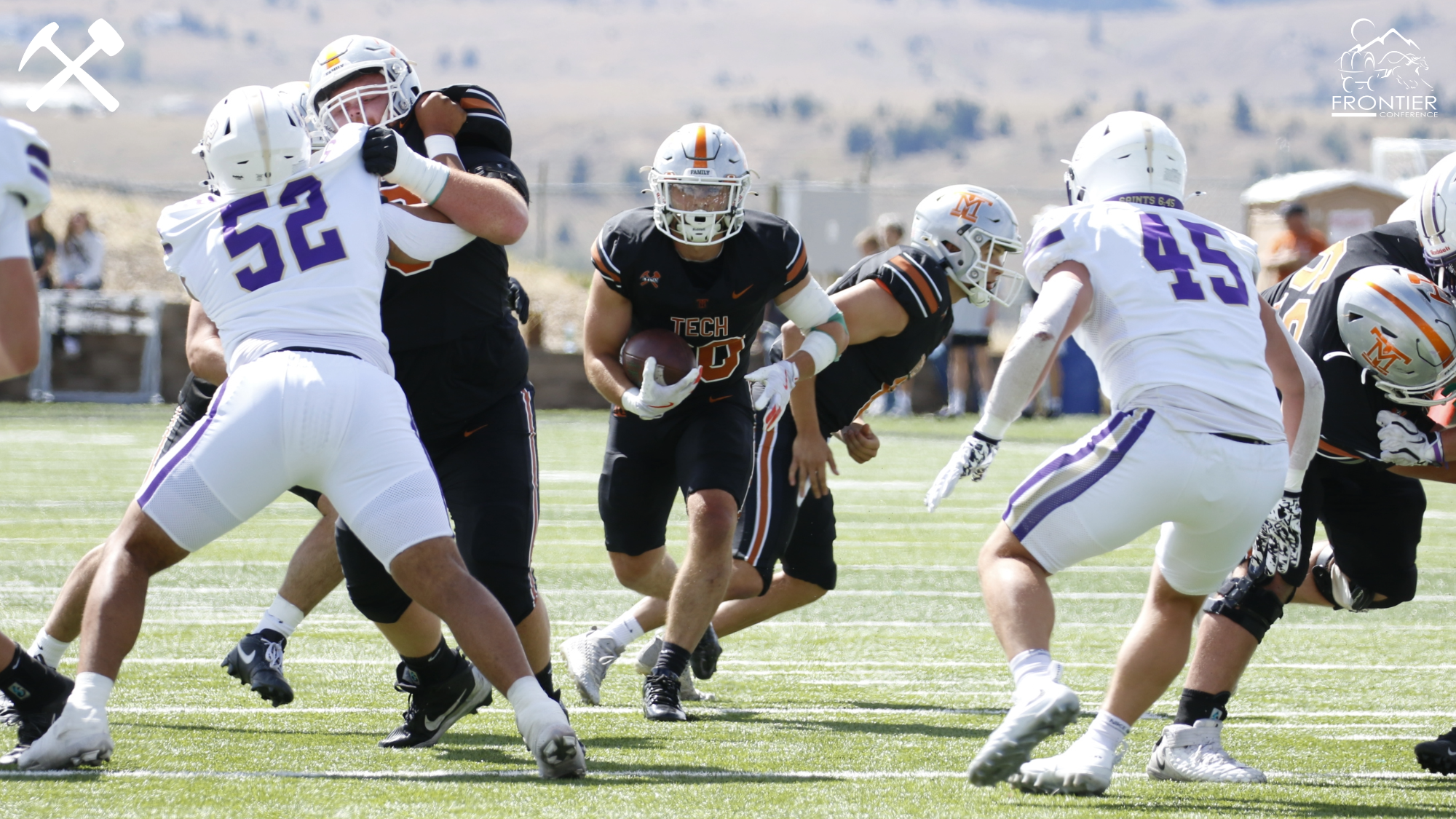 Ikaika Ho runs through a gap in the Carroll defense during a Montana Tech football game
