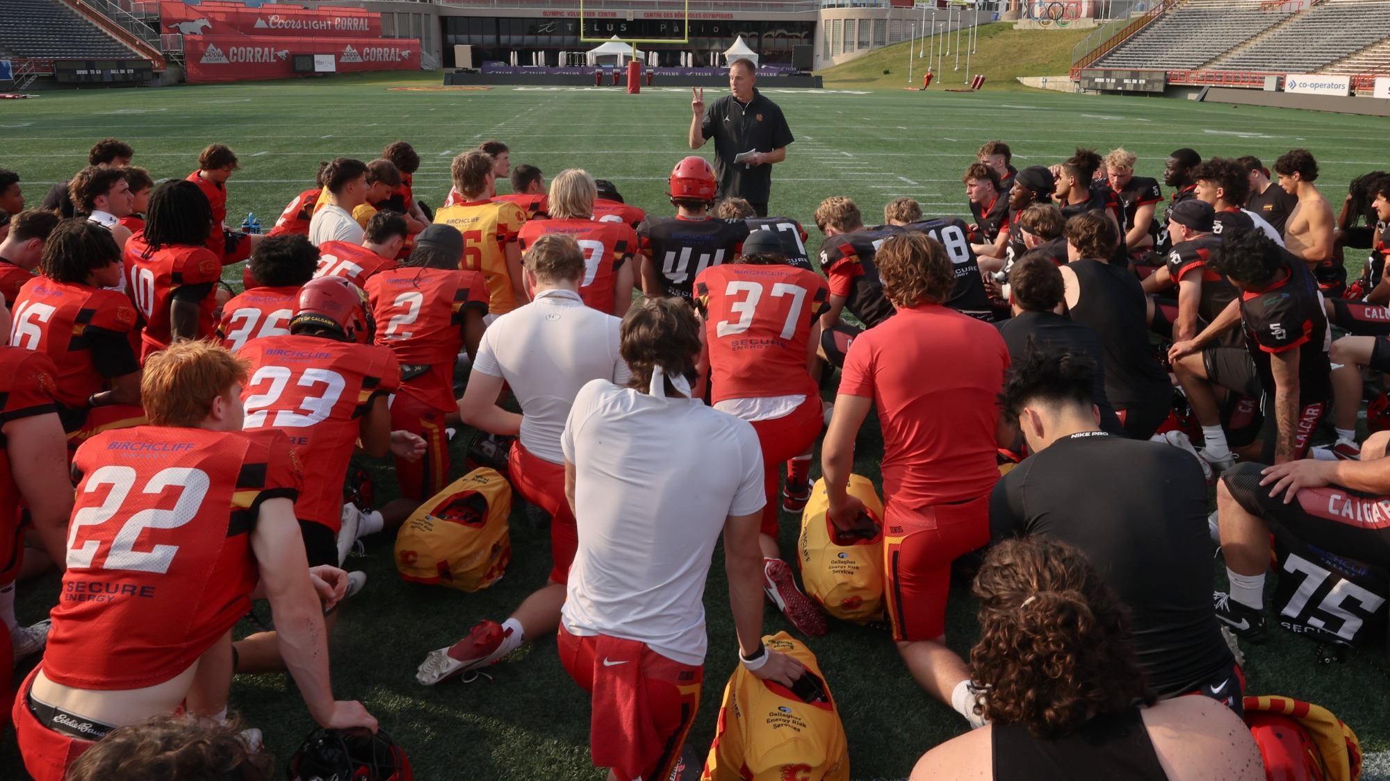 Dinos Football huddle