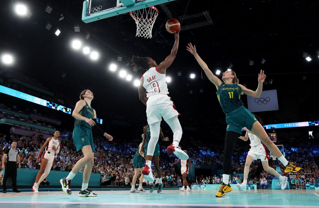 PARIS, FRANCE - AUGUST 09: (EDITORS NOTE: Image was captured using a remote camera) Chelsea Gray #8 of Team United States goes up for a basket over Alanna Smith #11 of Team Australia during a Women's semifinal match between Team United States and Team Australia on day fourteen of the Olympic Games Paris 2024 at Bercy Arena on August 09, 2024 in Paris, France. (Photo by Sarah Stier/Getty Images)