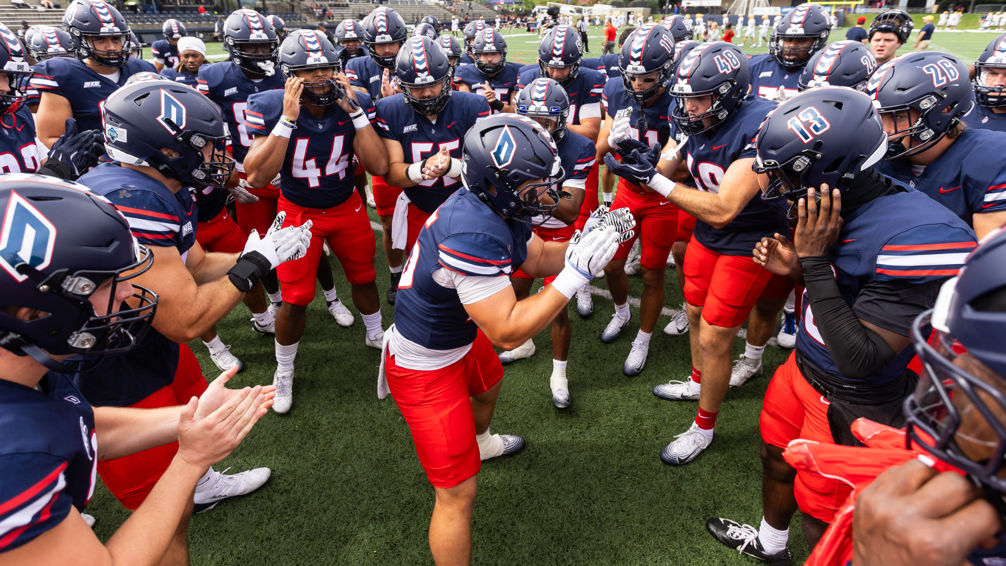 football pregame huddle before 2025 game vs. new haven