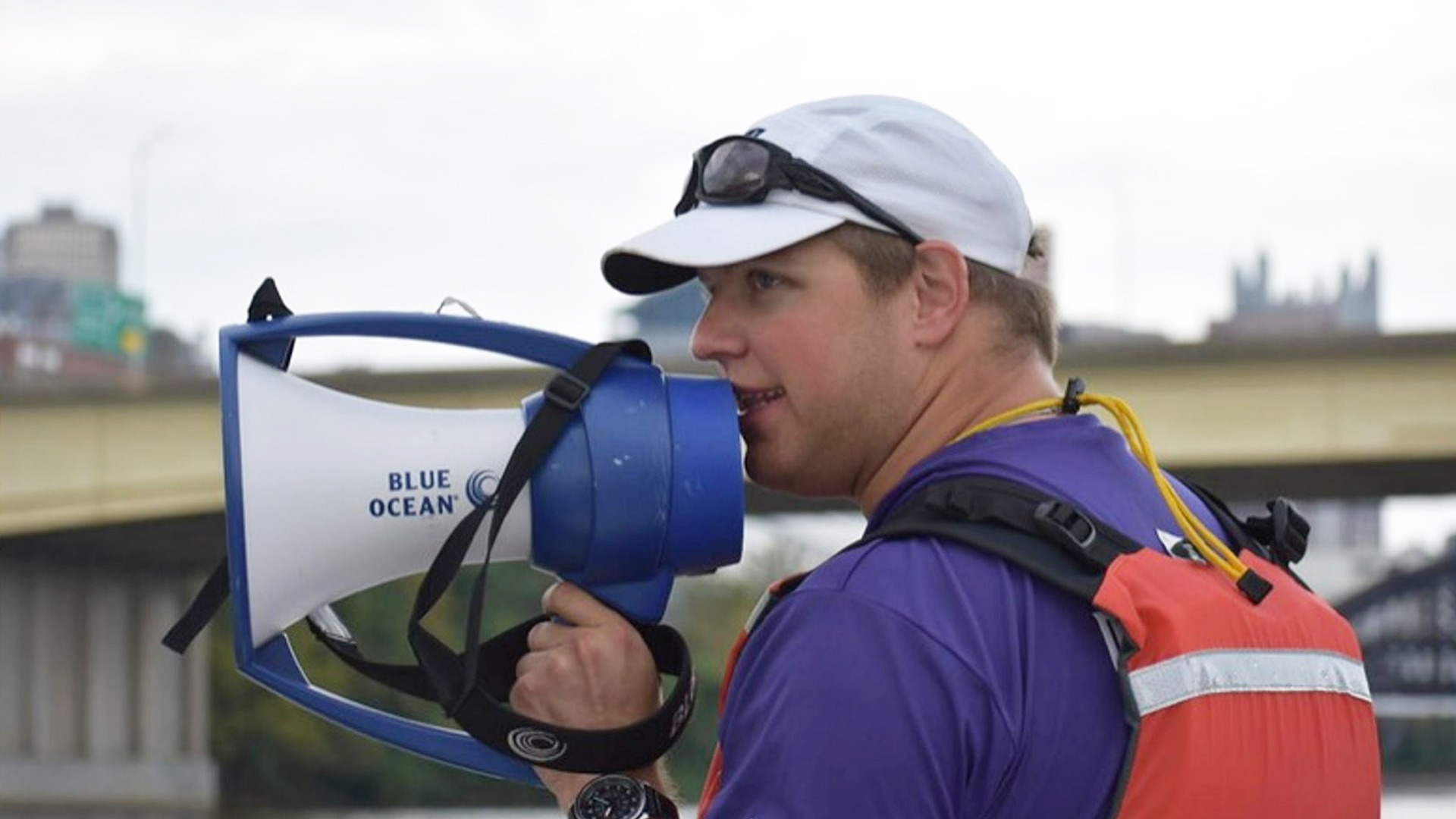 New Associate Head Coach Stephen Eckstein of the Duquesne rowing program instructs boats on the river.