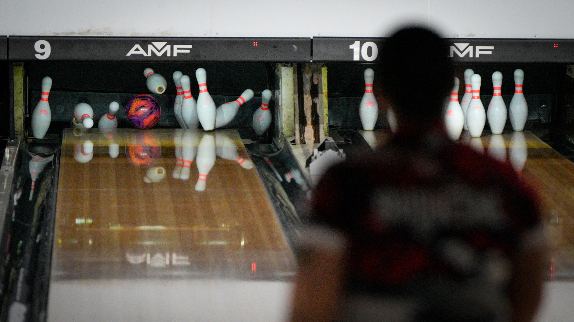 Picture of pins falling with bowling ball at AMF Mt. Lebanon Lanes during NCAA Championship.