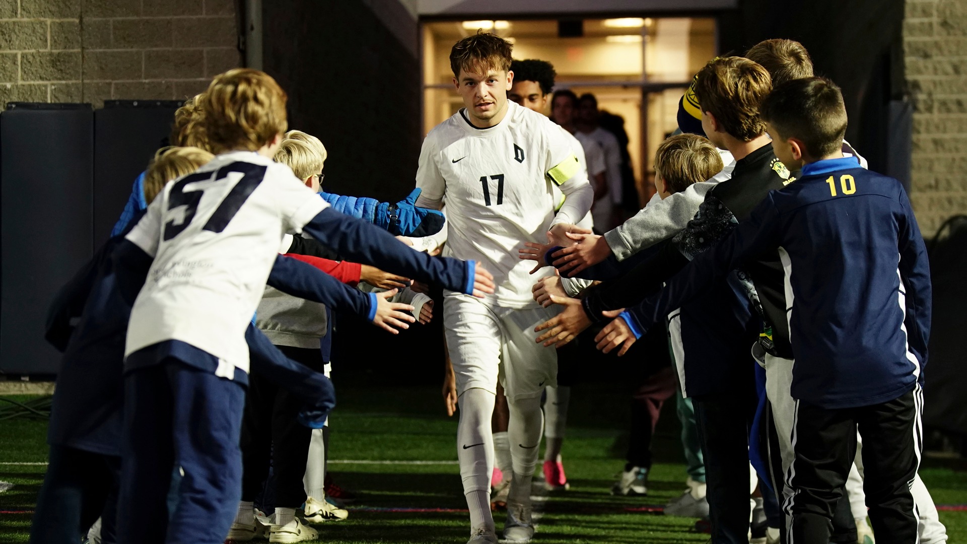 Jaxon Ervin running onto the field during Youth Day at Rooney Field.