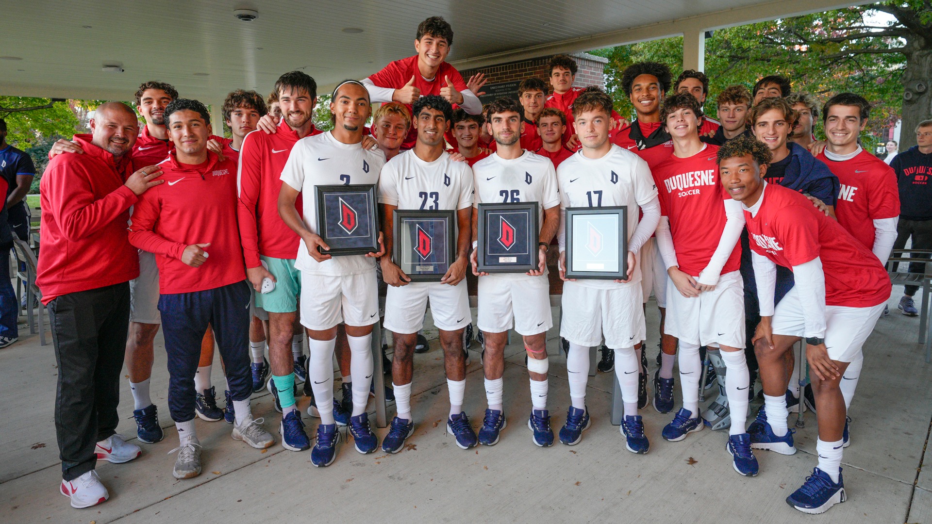 Duquesne Senior Day group picture at Unico Pavilion next to Roone Field.